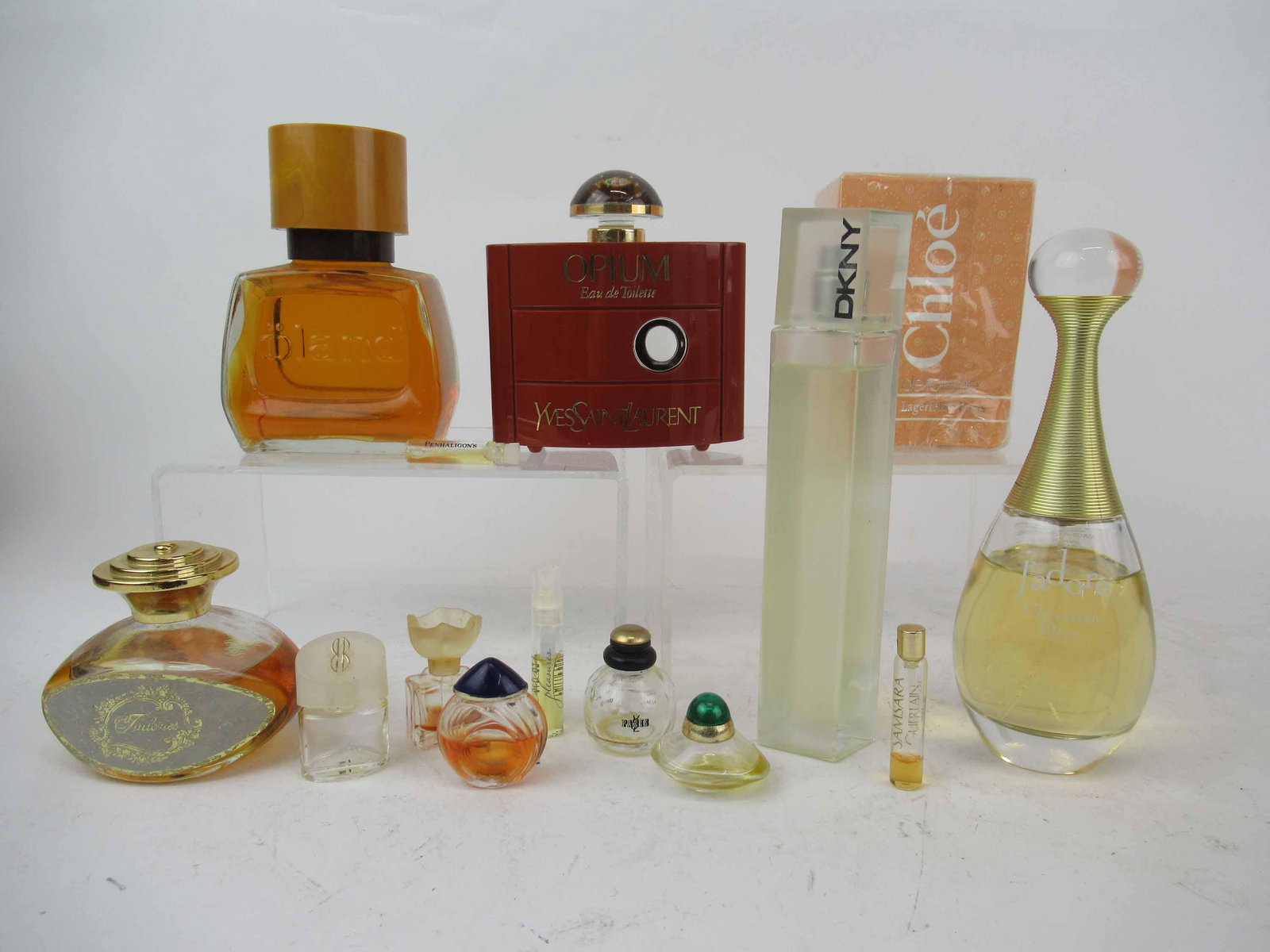 Group of Assorted Vintage Perfume Bottles: Group of Assorted Vintage Perfume Bottles. Including Y Eves Saint Laurent Opium Eau De Toilette 2 oz bottle 1/4 full, unopened Chloe Parfums Lagerfeld Eau De Toilette 2 oz, J'adore by Christian Dior 3