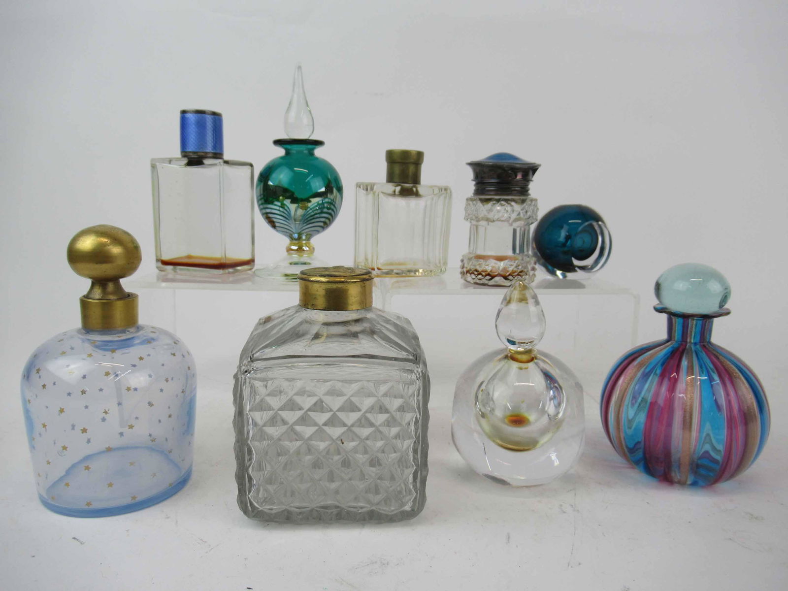 Group of Assorted Perfume Bottles: Group of Assorted Perfume Bottles. Including two crystal bottles with enamel decorated tops, 2 Kosta perfumes one missing lid, blue opalescent marked France, Murano Style and diamond point design bott