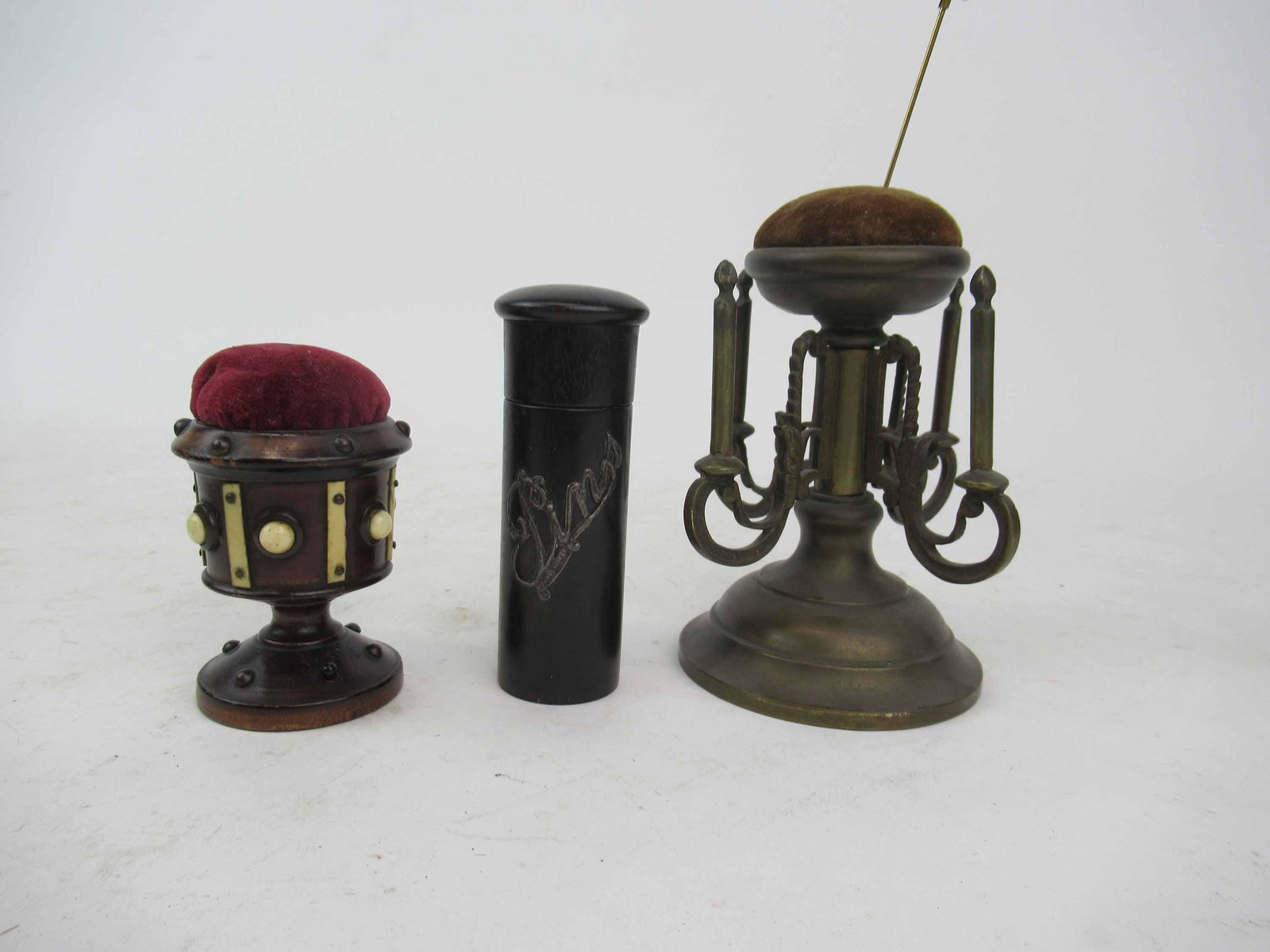 Victorian Brass Revolving Thread Spool Holder: Victorian Brass Revolving Thread Spool Holder with Pin Cushion together with an Anglo Indian Bone Mounted pin cushion and a wooden cylinder hat pin box with threaded lid and attached silver 'Pins' hal