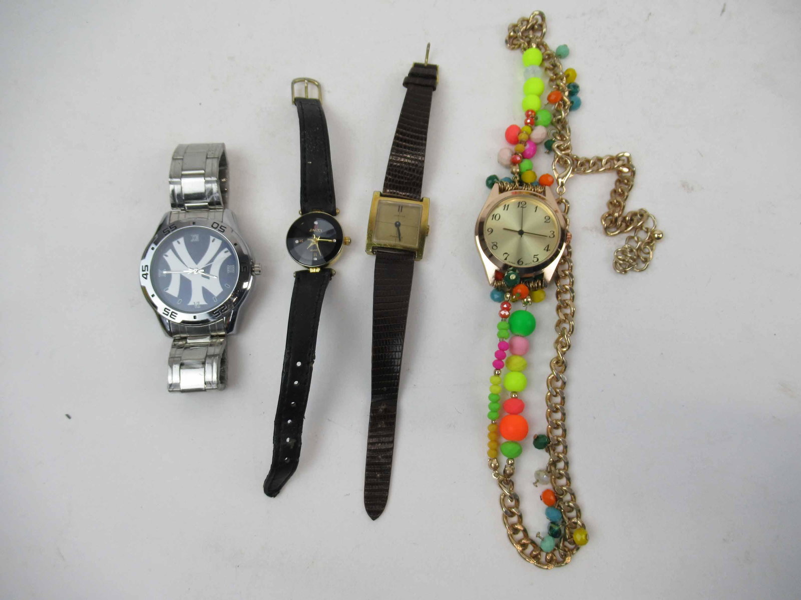 Group of Assorted Watches: Group of Assorted Watches including, NY Yankees stainless watch, Vivani quartz bangle watch, Zacci quartz watch, Jubilee, Japan movement watch mounted onto costume necklace. Used condition, wear, worn