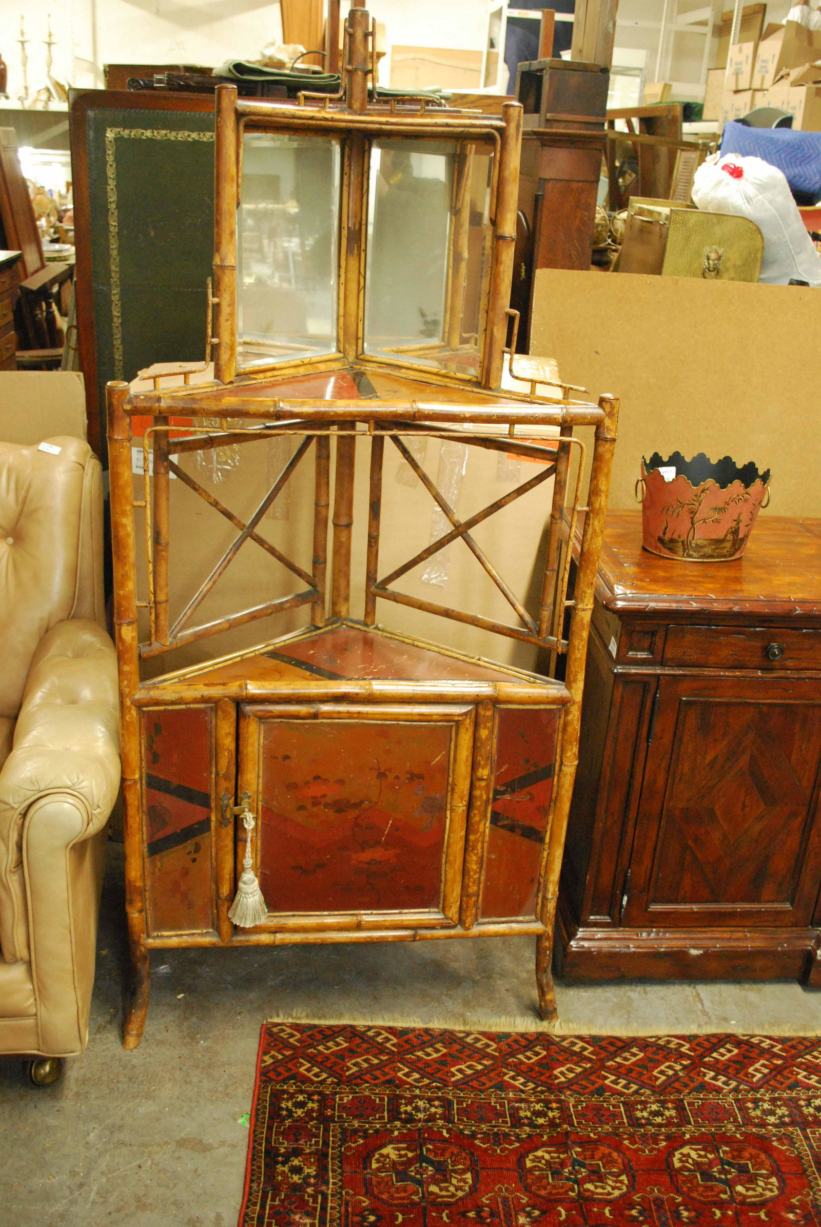 Asian Decorated Bamboo Corner Etegere: Asian Decorated Bamboo Corner Etegere with single door and mirror back. Used condition, wear, worn. 64 3/4" tall x 30 1/3" wide x 22" deep