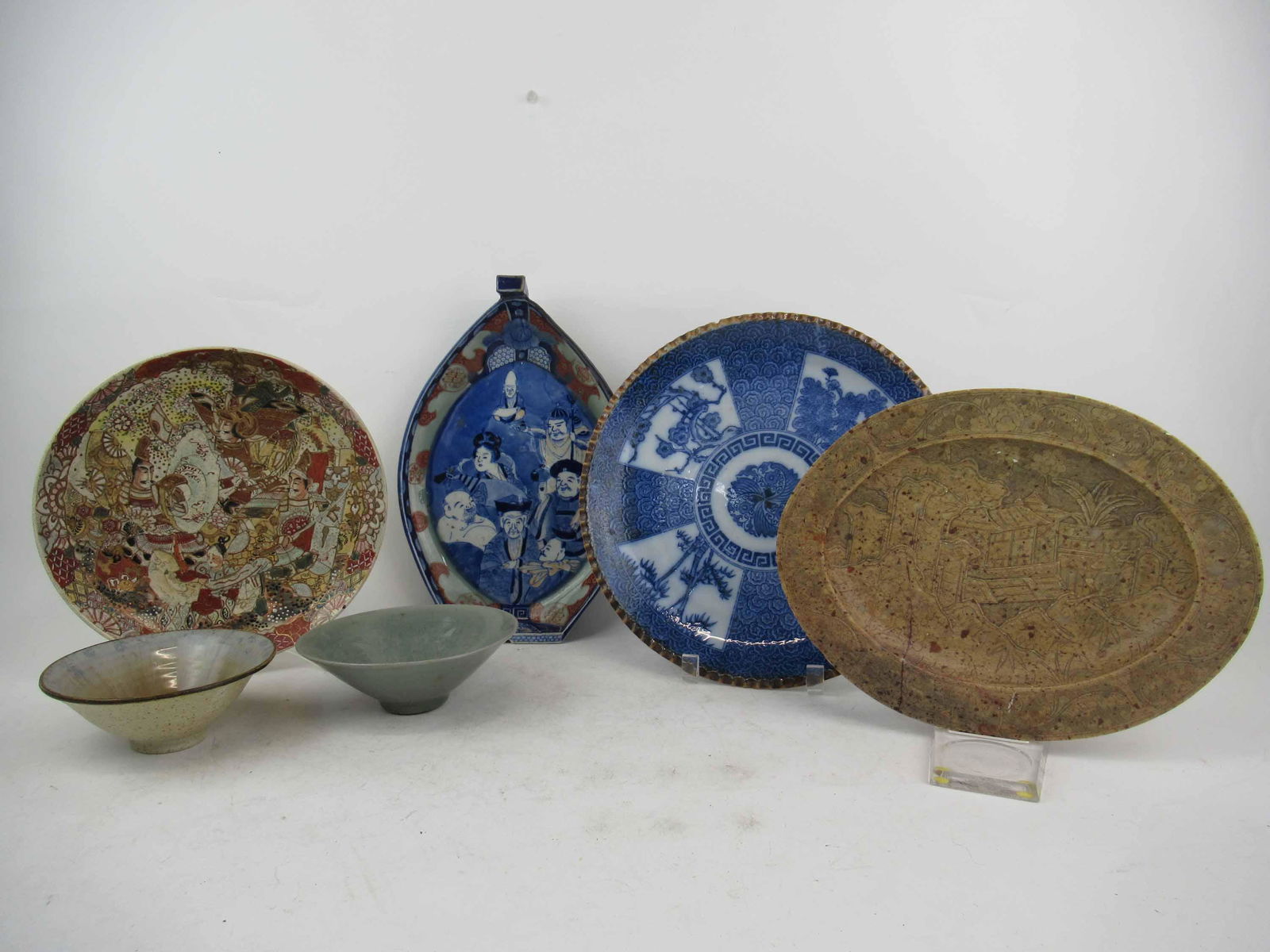 Group of Assorted Asian Serving Articles: Group of Assorted Asian Serving Articles. Including Japanese Imari Porcelain Open Boat Shaped Dish, Satusma bowl, Chinese blue and white decorated charger, Carved stone platter with crack and 2 rice b