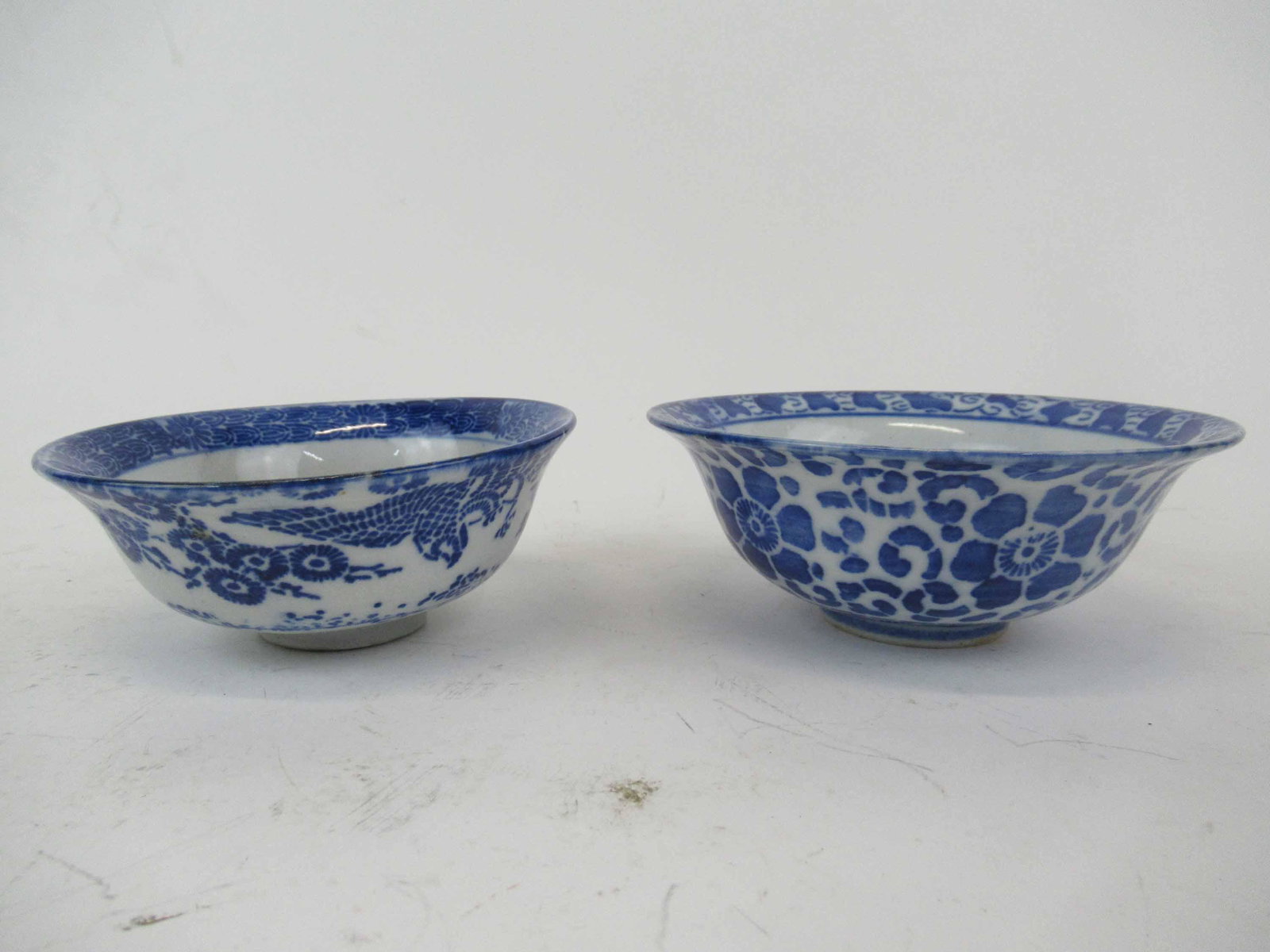 Two Antique Blue and White Chinese Bowls: Two Antique Blue and White Chinese Bowls. One decorated with birds and flowers, the other floral decoration. Used condition, minor chips to underside. Largest bowl 5 3/8" x 2 1/8" tall.