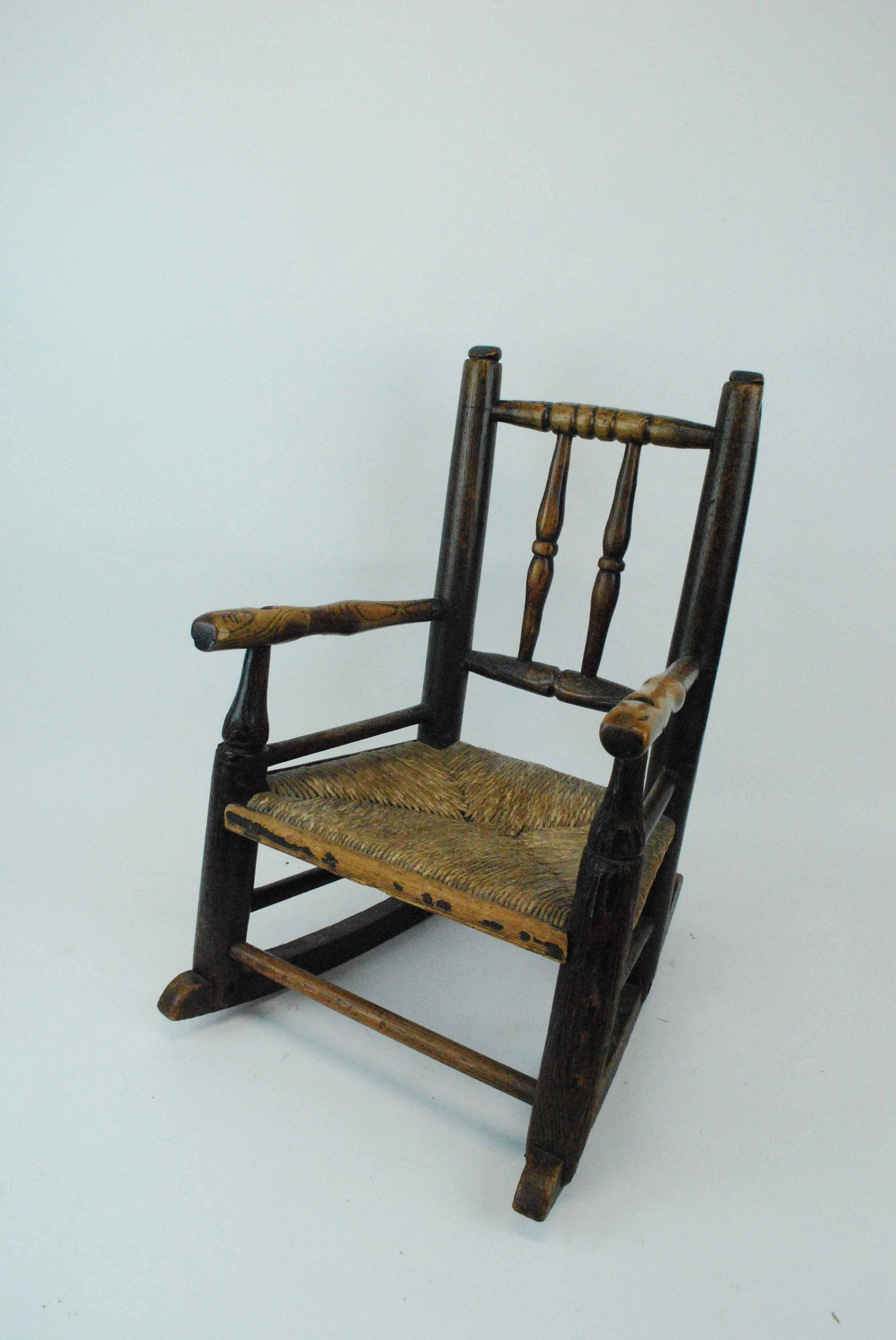 Primitive Child's Rocker: Primitive Child's Rocker with rush seat. Condition: Used. 21" tall x 14"wide x 17 1/2" deep
