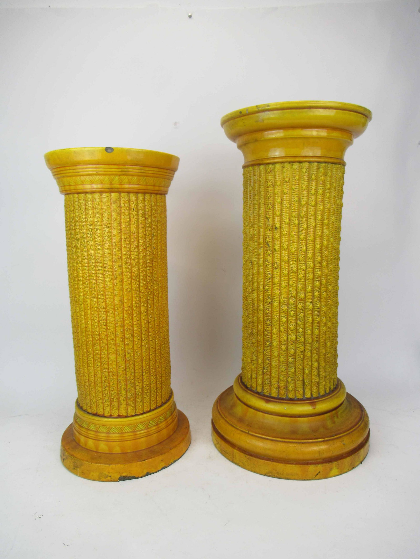 2 Antique Burmantofts Faience Yellow Pedestals: 2 Antique Burmantofts Faience Lemon Yellow Pedestals, each having reeded columns. Used condition, wear, worn. smaller of the two has cracks , chips to side and base along with chip to top rim. Largest