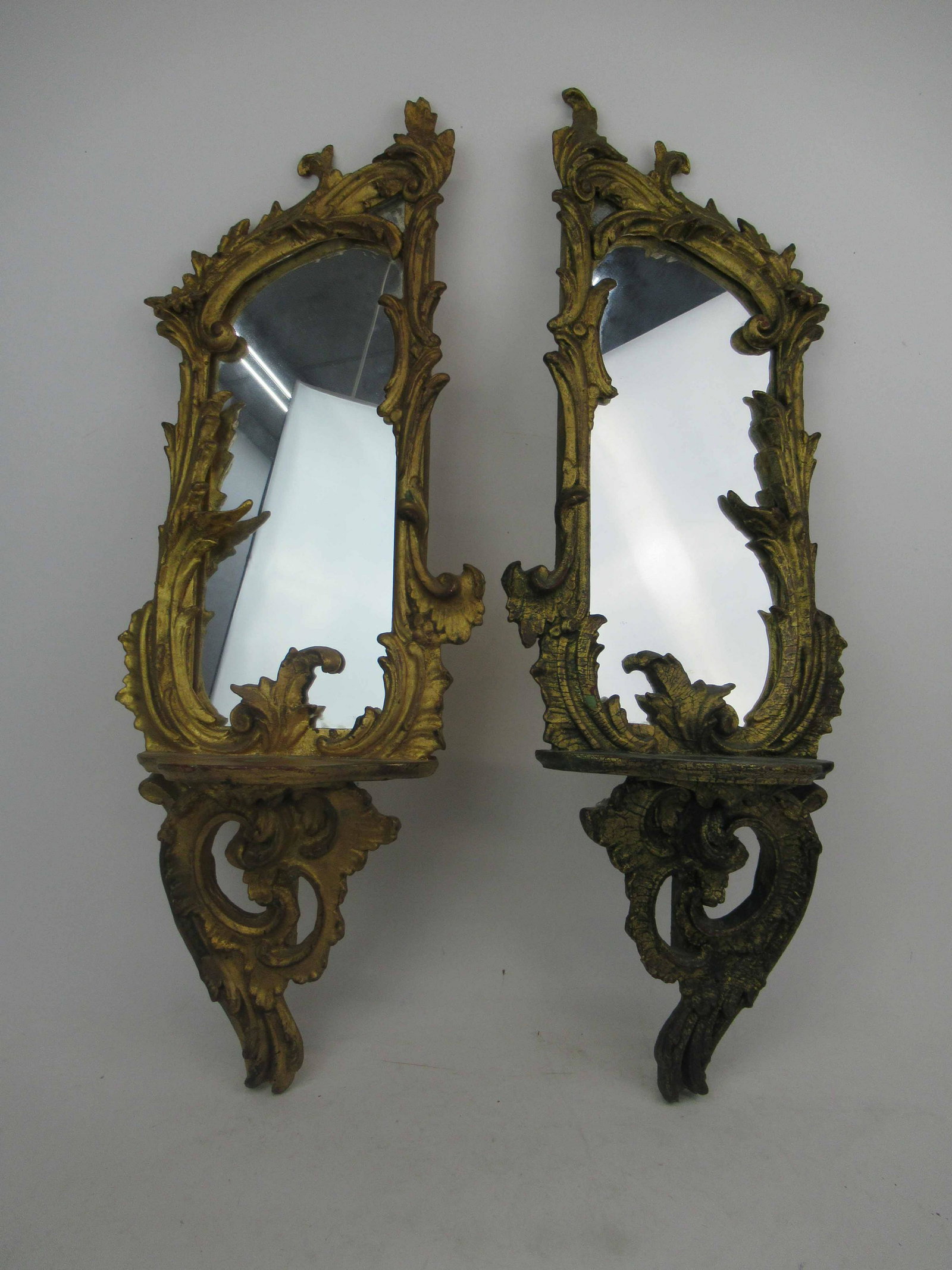 Italian Carved and Gilt Mirrored Bracket Shelves: Near Pair of Italian Carved and Gilt Mirrored Bracket Shelves. Used condition, paint losses, difference in color. 31 1/2" tall x 11 3/4" wide x 5 1/4" deep.