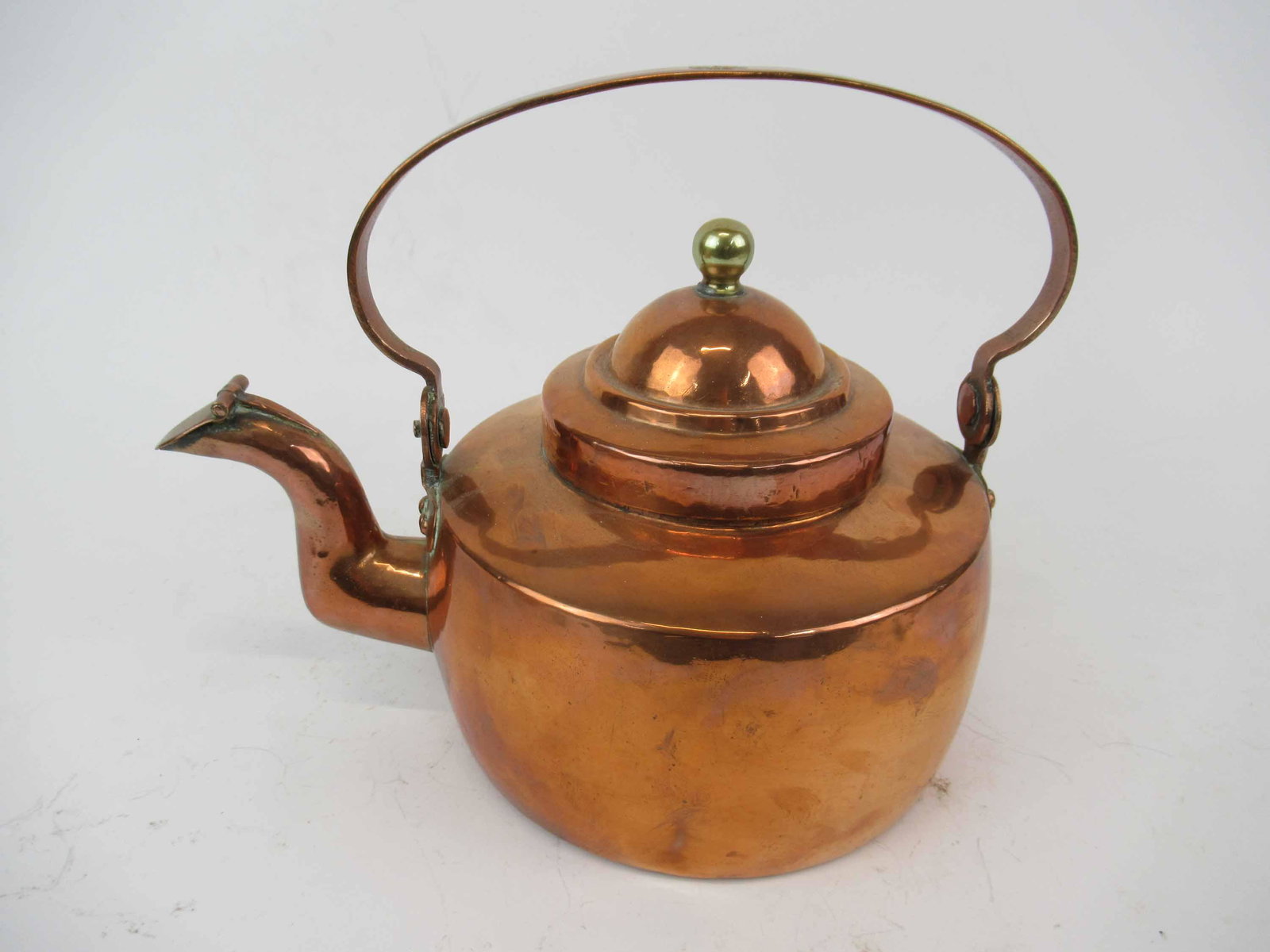 Antique Copper Hot Water Kettle: Antique Copper Hot Water Kettle. Having dovetailed base and side. Copper rivets and makers on top of handle. Used condition, dents. 9 3/4" tall to top of handle when up x 12" long from spout to end of