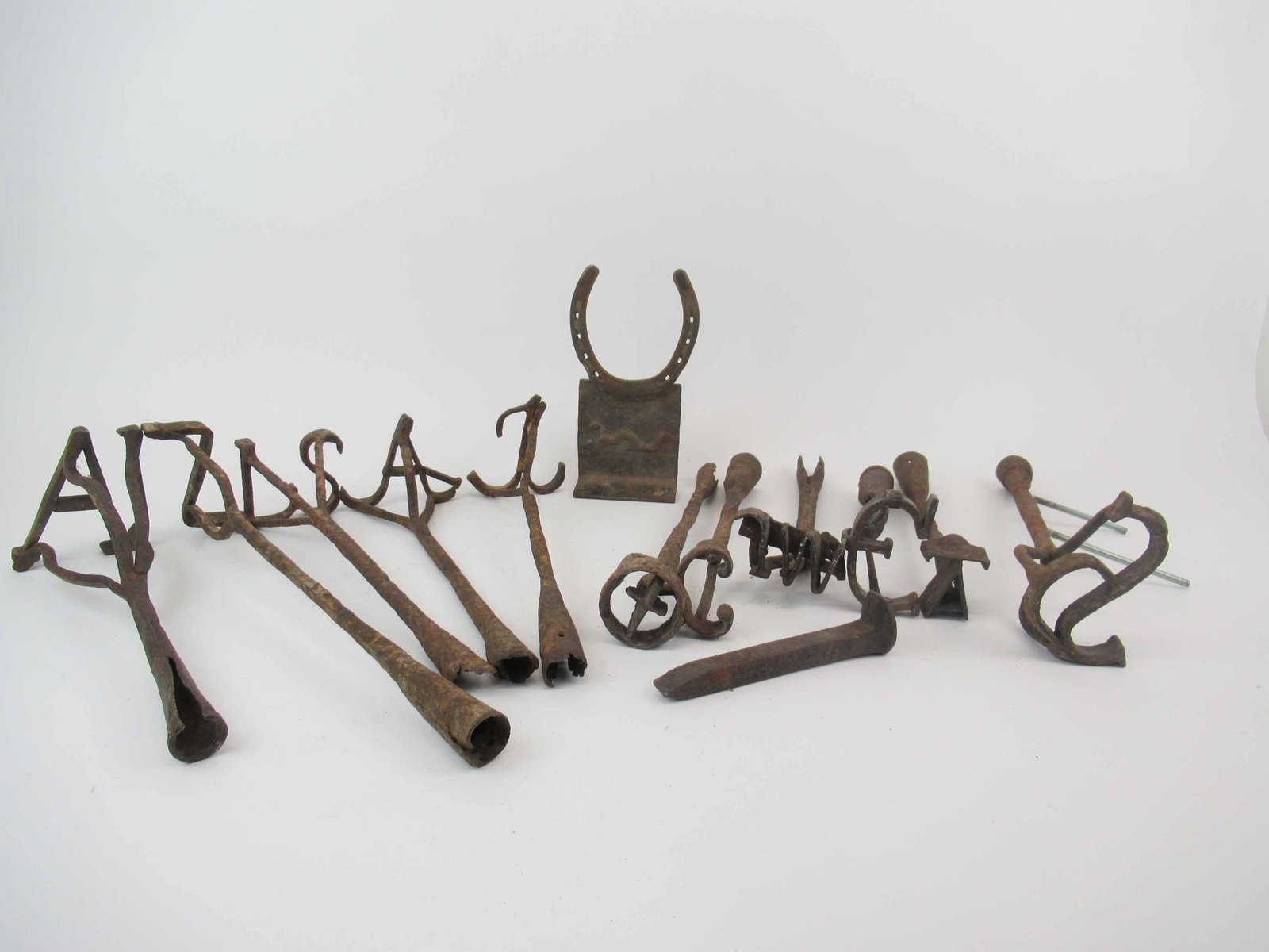 Group of 11 Vintage Cattle Branding Irons: Group of 11 Vintage Cattle Branding Irons with Ranch identifiers, used condition, wear, worn. longest is 16 1/2" long