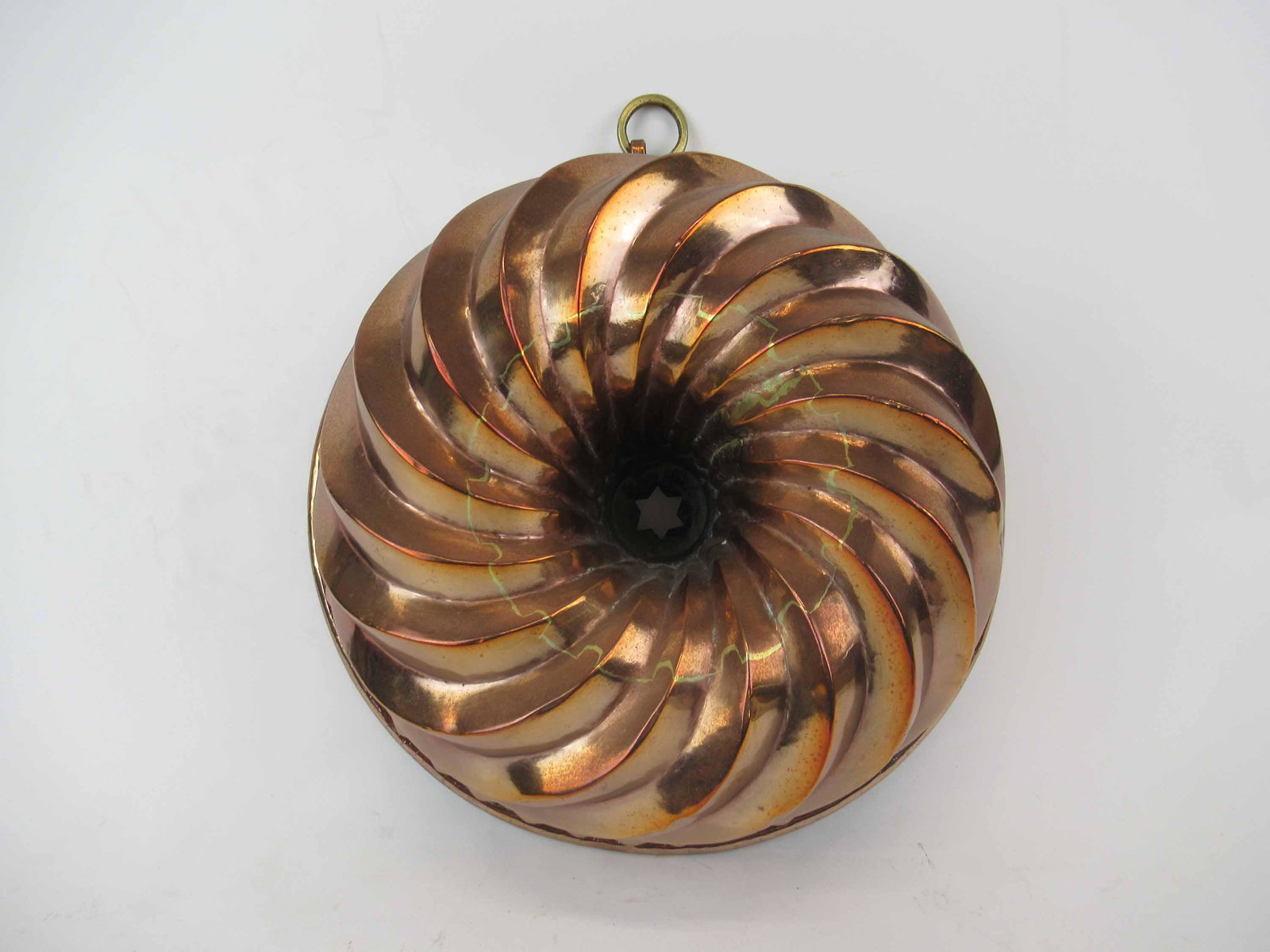 Antique Heavy Copper Food Baking Mold: Antique Heavy Copper Food Baking Mold. Having central star with a bunt cake design. Dovetailed on base. Used condition, dents. 10 3/4" diameter x 4 1/4" tall