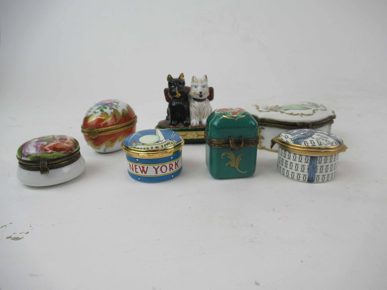 Group of Assorted Battersea Style Pill Boxes: Group of Assorted Battersea Style Pill and Trinket Boxes. Including Halcyon Days for Tiffany Enamels 1989 worlds fair 50th anniversary, Limoges France Peint Maine perfume box, Cartier box with broken 