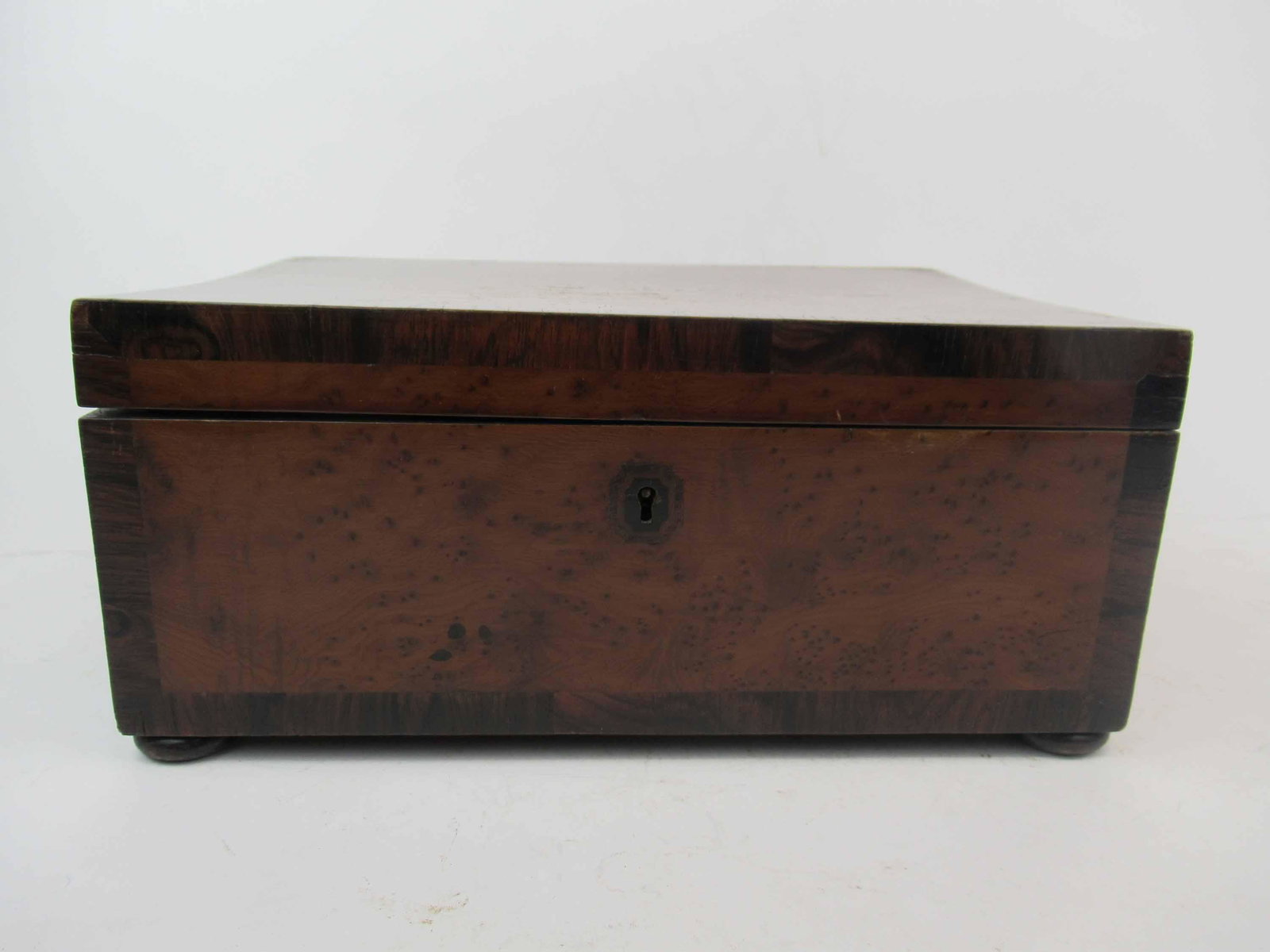 Antique Burlwood Sewing Box: Antique Burlwood Sewing Box with hinged top opening to removable 9 lidded drawer. Used condition, wear, worn, surface distress,, missing veneer, loose corner. 12" x 8 3/4" x 5 1/2" tall