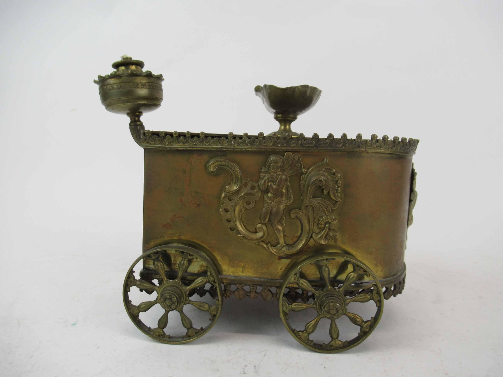 Antique Brass Art Nouveau Style Fairy Lamp: Antique Brass Chariot Form lamp with Fairy decorated sides. Used condition, wear, worn, maybe missing pieces. 9 1/4" long x 5 1/2" wide x 7 1/4" tall