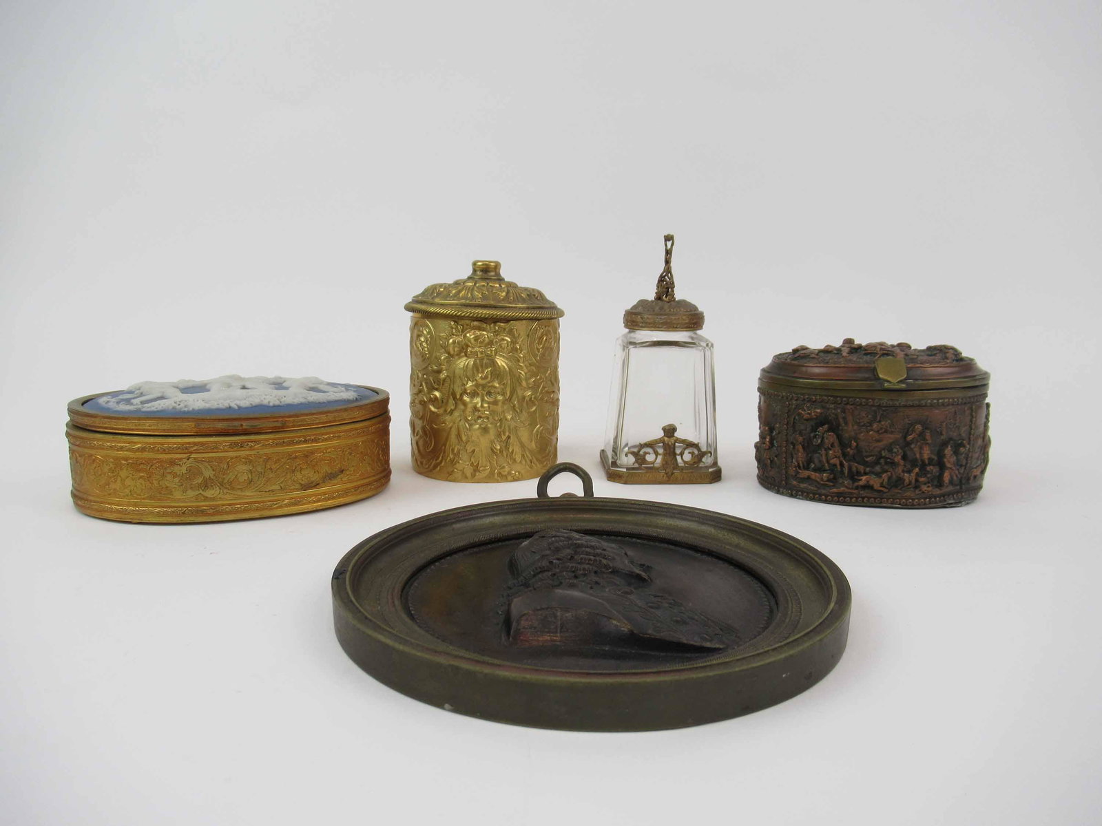 Antique Dutch Copper Embossed Hinged Box: Antique Dutch Copper Embossed Hinged Box. Together with a Wedgwood style brass hinged dresser box, figural bronze plaque, brass North Wind decorated string thread holder and a bronze mounted glass ink