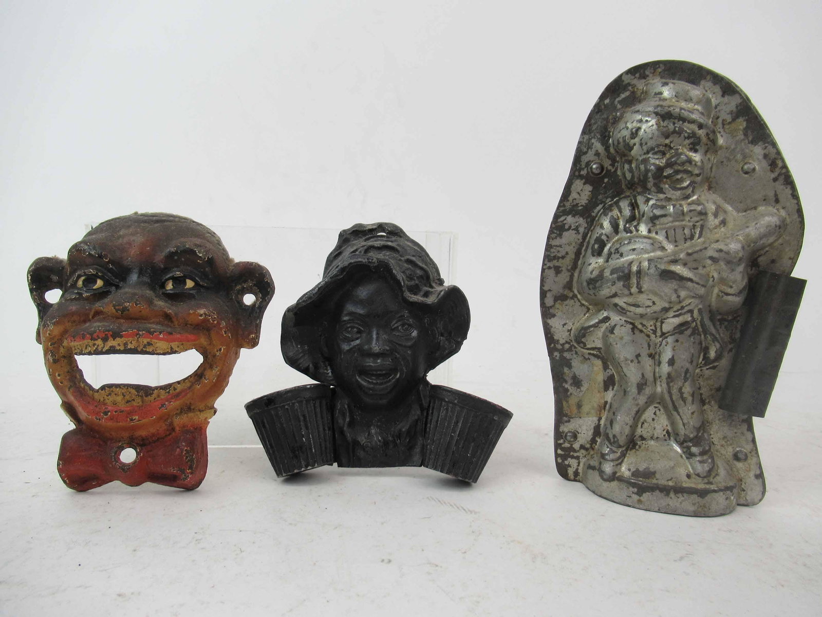 Cast Iron Black Americana Bottle Opener: Cast Iron Black Americana Bottle Opener. Together with a match holder and a minstrel chocolate mold. Used condition, wear, worn, paint loss.