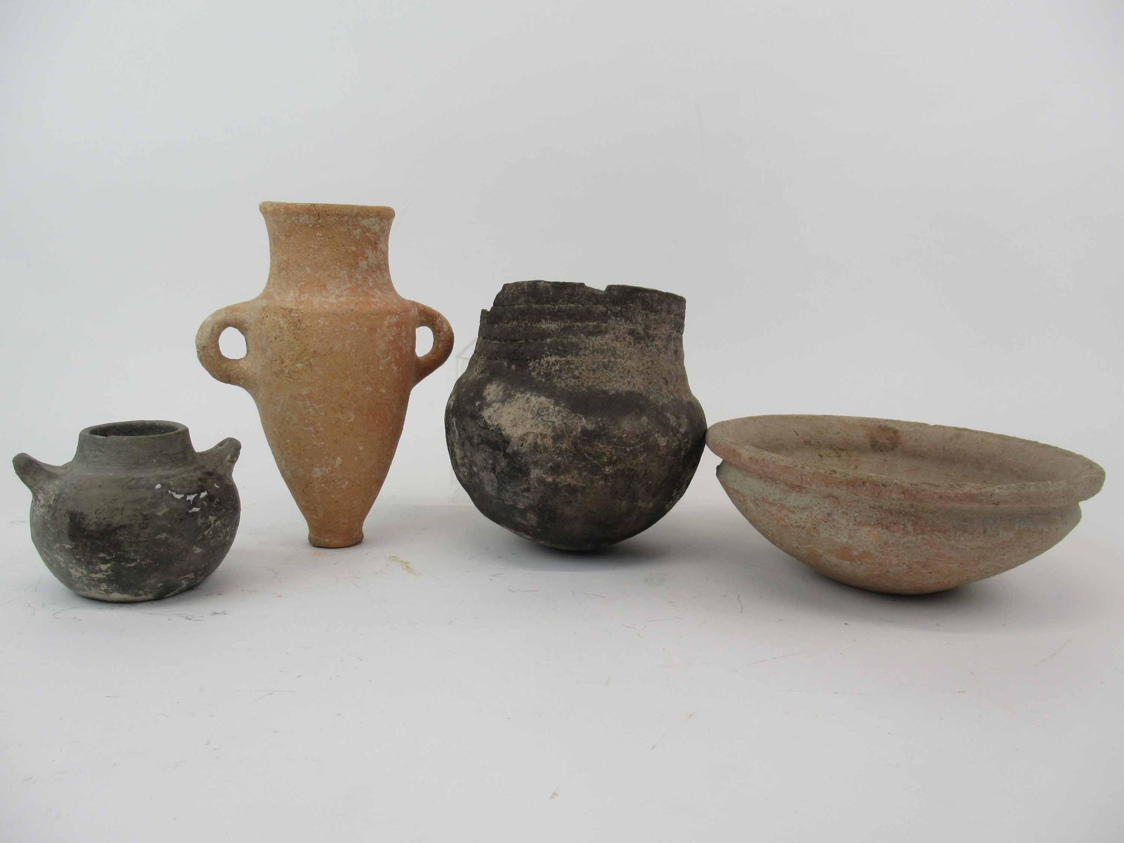 Group of Assorted Earthenware Vessels: Group of Assorted Earthenware Vessels. Including a low bowl, 2 handled vases and cracked vessel. Used condition, wear, worn, cracks. Low bowl 8 1/2" diameter x 3 1/4" tall