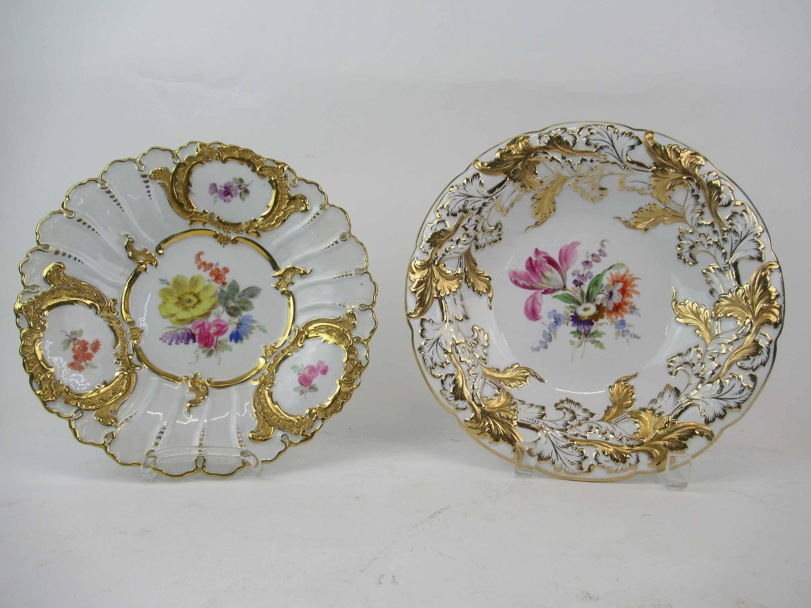 Two Meissen Rococo Gilt Porcelain Bowls: Two Meissen Rococo Gilt Porcelain Bowls including a bowl with embossed leaf border and central flowers and shallow bowl/plate with with painted flowers in cartouche, largest bowl (leaf) measures 10" i