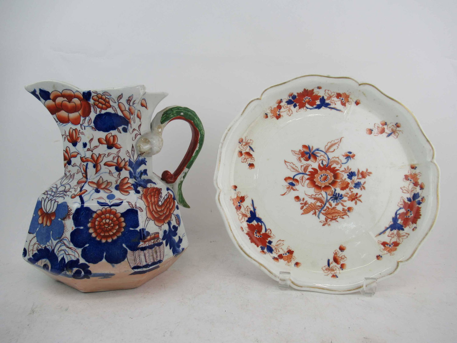 Antique Mason's Ironstone Hydra Jug: Antique Mason's Ironstone Hydra Jug with serpent handles. Together with footed floral decorated cake plate. Used condition, paint loss, 9 1/2" tall x 8" diameter.