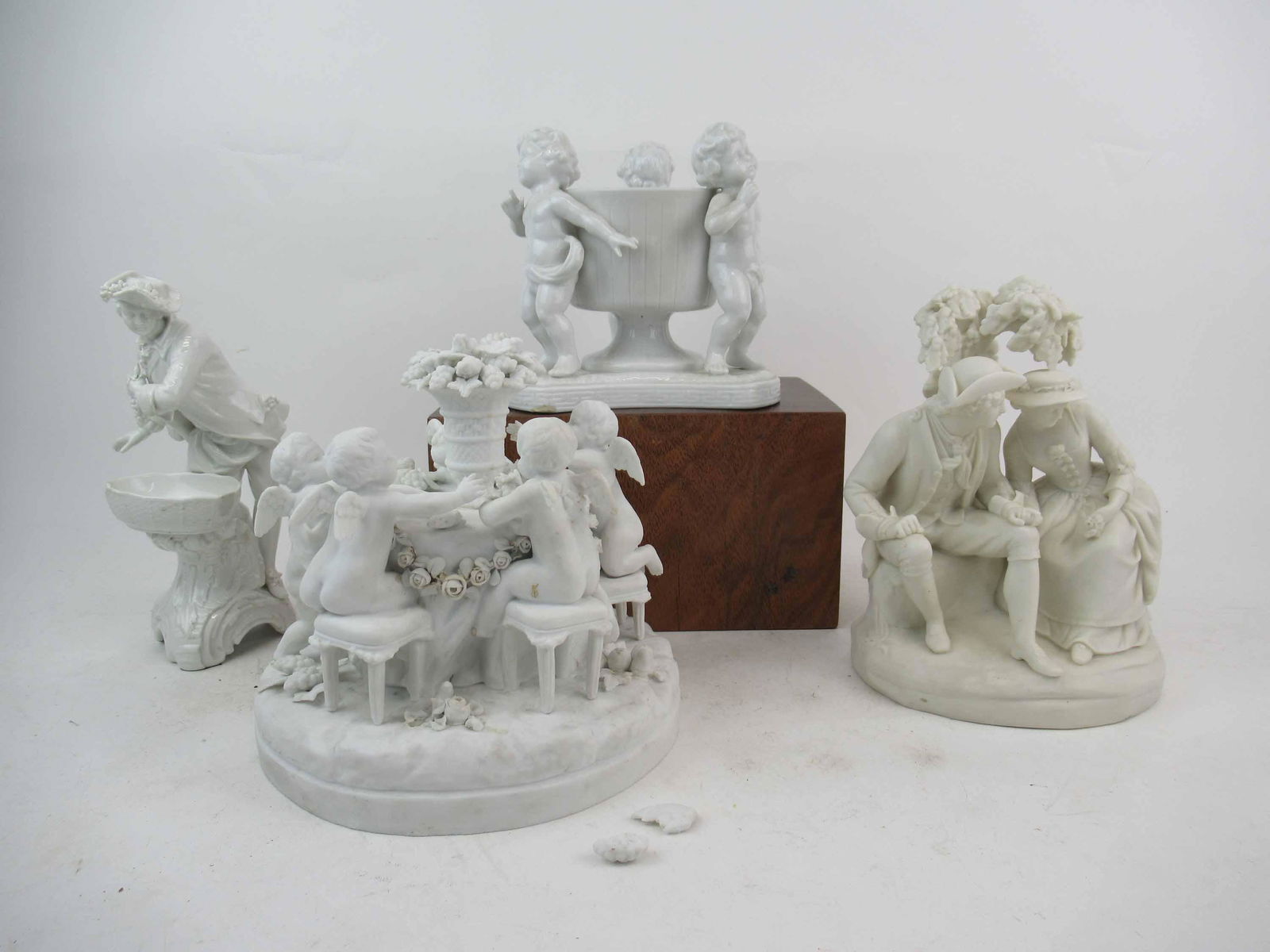 Copeland Parian Figural Group: Copeland Parian Figural Group chips to tree and flowers. Together with a KPM Master salt with repairs and chips, Cherub decorated centerpiece porcelain bowl missing fingers and a Continental porcelain