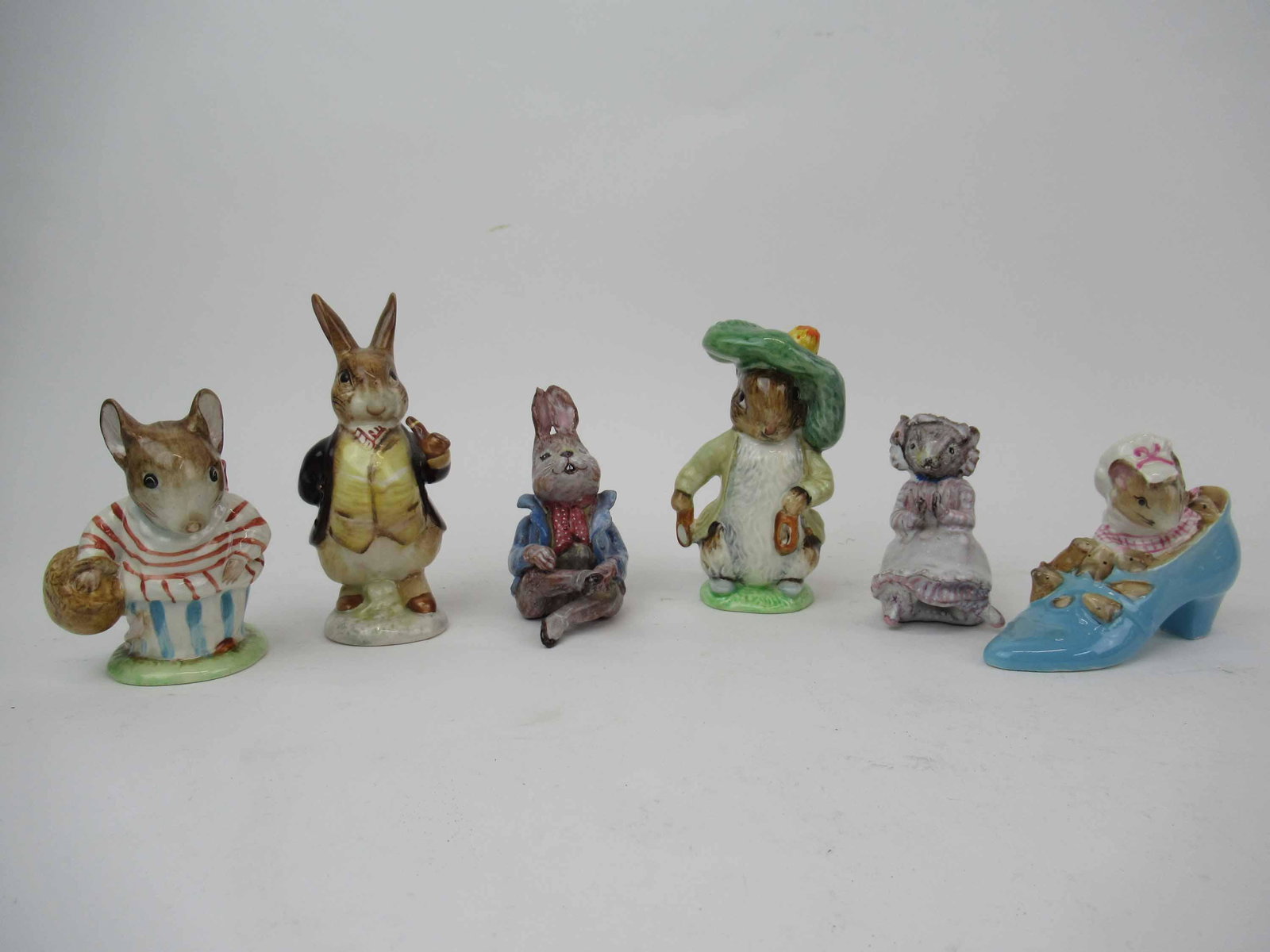 Four Beatrix Potter Beswick Porcelain Figurines: Four Beatrix Potter Beswick Porcelain Figurines including Mr Benjamin Bunny, Mrs Tittlemouse, The Old Woman Who Lived in a Shoe and Benjamin Bunny together with two ceramic figurines, of Peter Rabbit 