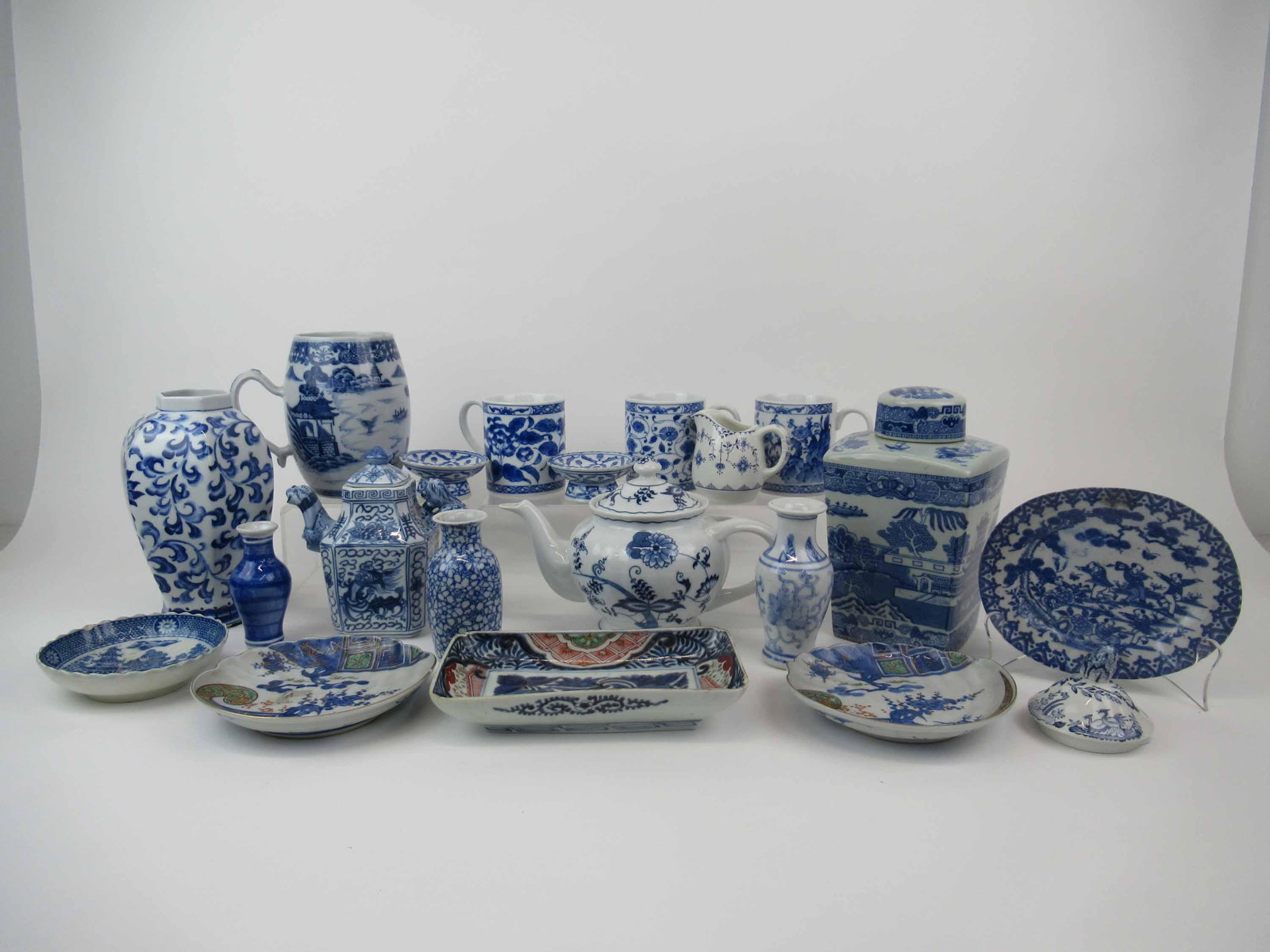 Group of Assorted Porcelain Table Articles: Group of Assorted Blue & White Porcelain Table Articles including a vintage Rington's Blue Willow Tea Caddy, Chinese dragon teapot, Blue Danube teapot, Furnivals Denmark creamer and assorted mugs, vas