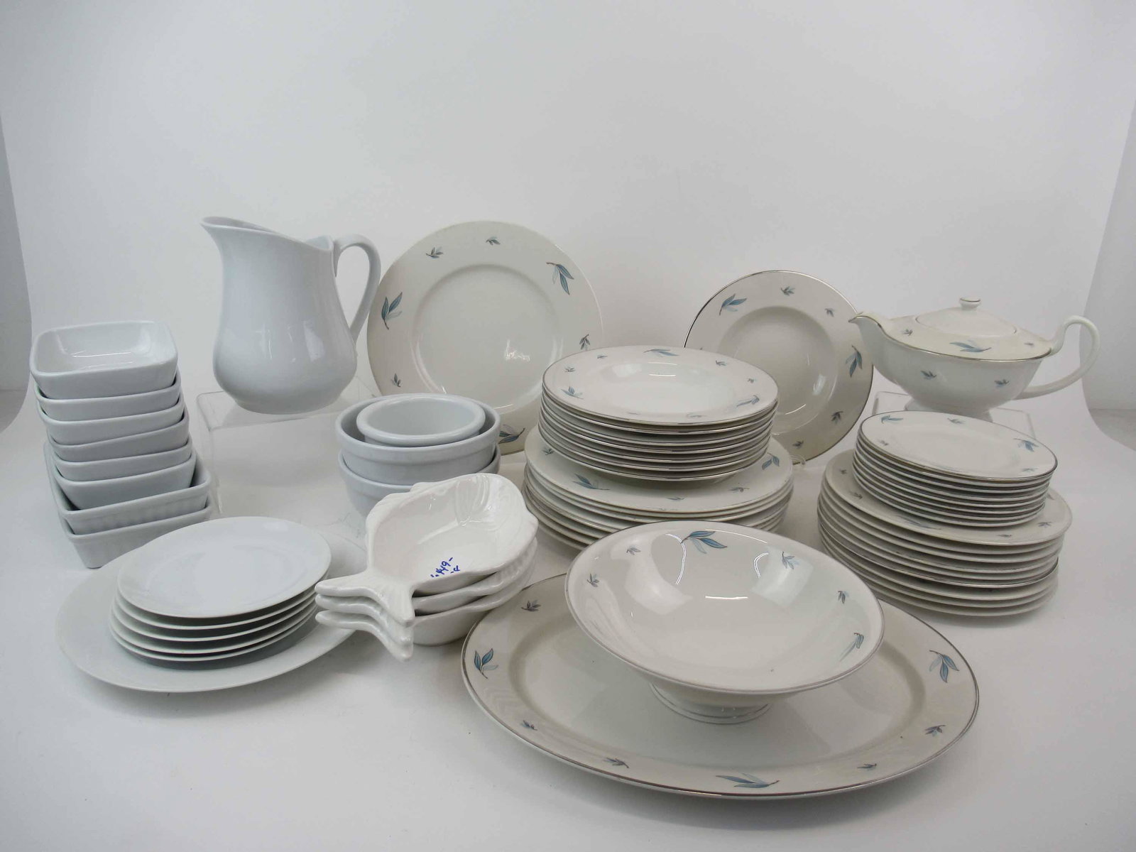 Partial Set Syracuse Celeste Pattern Dinnerware: Partial Set Syracuse Celeste Pattern Dinnerware. Including tea pot, platter, round vegetable, 9 dinner plates, 9 salad plates, 8 bread and butter plates, 8 rimmed soup bowls, silver losses to rims, sc
