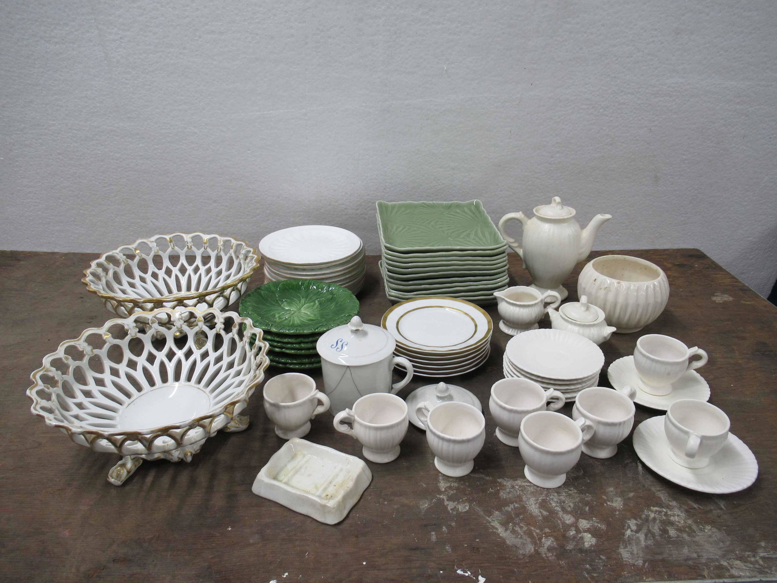 Group of Assorted Porcelain Table Articles: Group of Assorted Porcelain Table Articles. Including 12 square Sushi dishes, 6 cabbage plates, demitasse tea set, planter, 2 gold porcelain reticulated center bowls and 18 bread and butter plates.