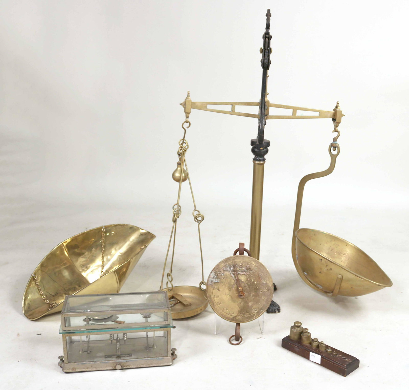 Four Assorted Scales: Comprising, a large brass and iron scale, 19th C., a case white metal scale, a brass and iron scale by John Chatillion & Sons hanging scale, with associated brass holder. 4 pieces Largest: 39-1/2"h