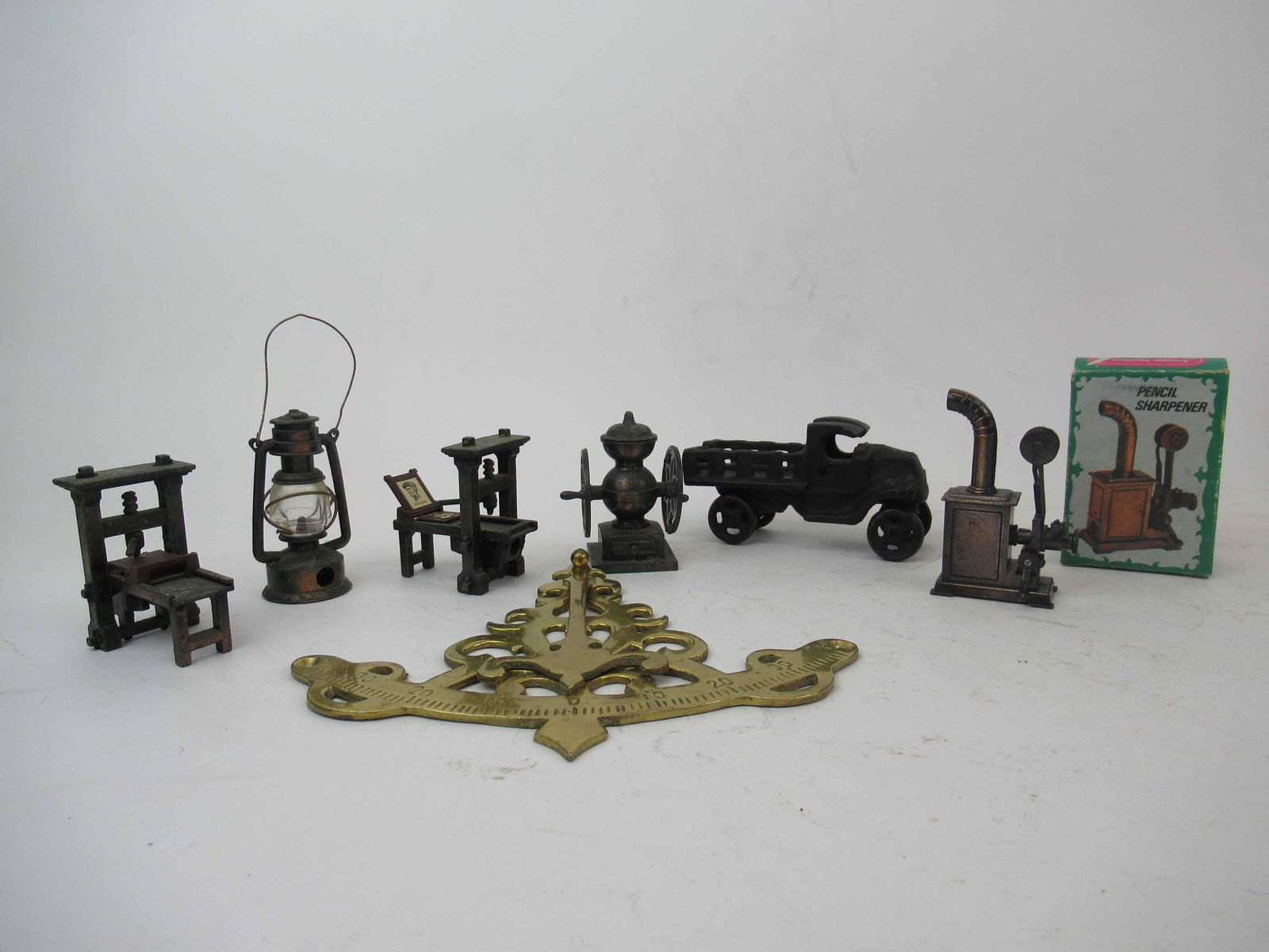 Five Die Cast Miniature Pencil Sharpeners: Together with a cast iron pick up truck and a brass tool. Size: Truck 4 1/2"l