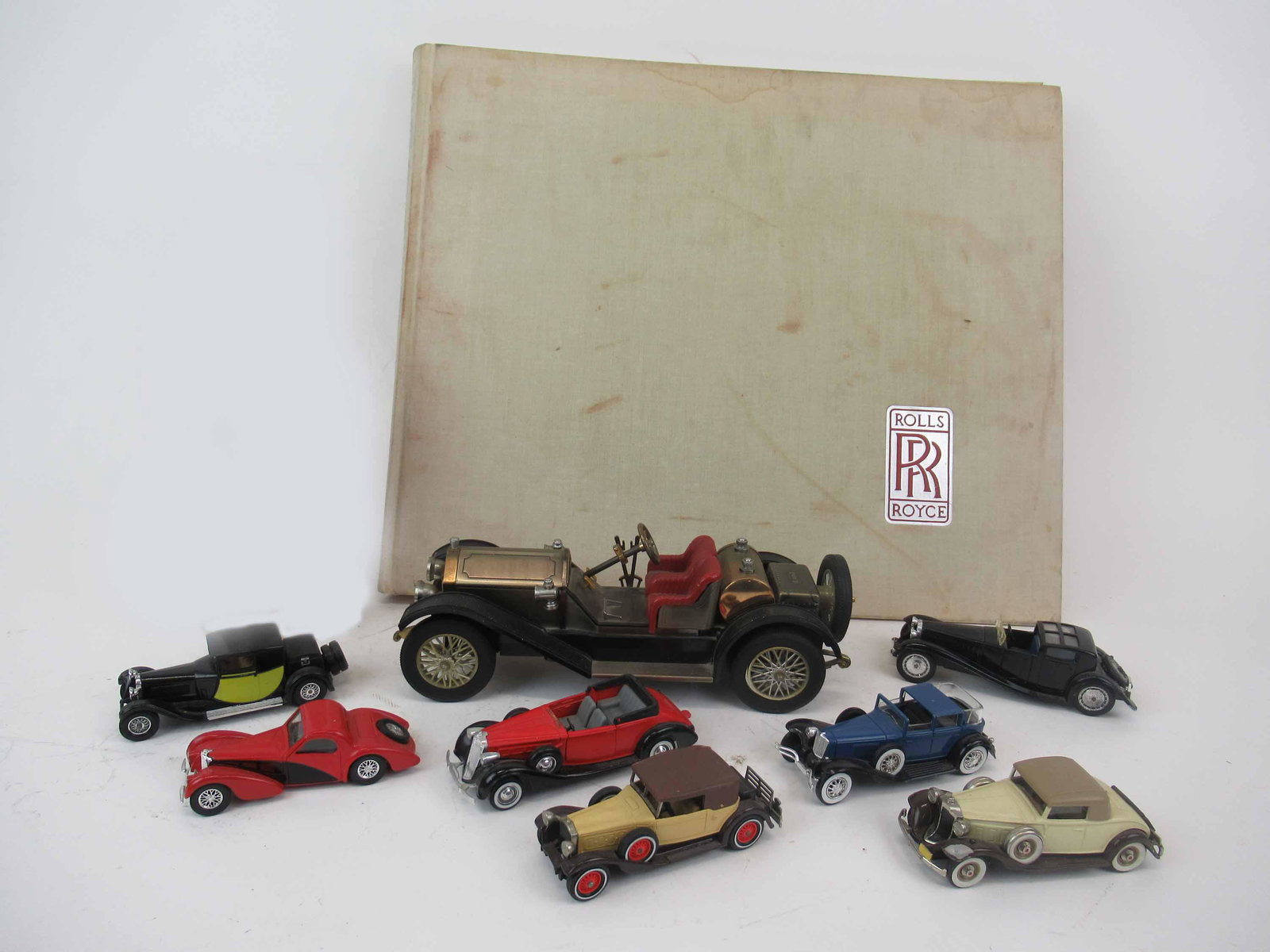 Group of 4 Assorted Solido Antique Cars: Group of 4 Assorted Solido Antique Cars. Together with Matchbox, Brooklyn Model, Lesney and Large Waco car. Along with a Rolls Royce Twenty Silver Ghosts book. Used condition, wear, worn, maybe missin