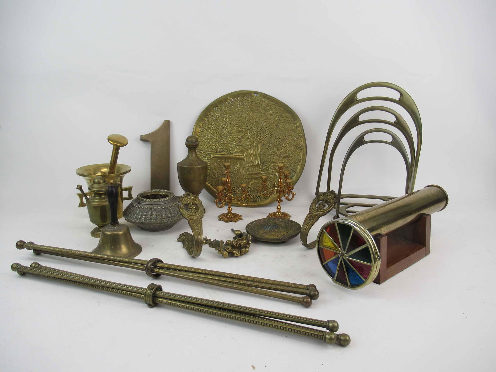 Group of Assorted Brass Table Articles: Group of Assorted Brass Table Articles. Inducing Gustave Keller Paris French Brass Lighter, mortar and pestle, kaleidoscope, tie backs, #1, bell, desk divider, hammered wall plaque, candelabras and ro