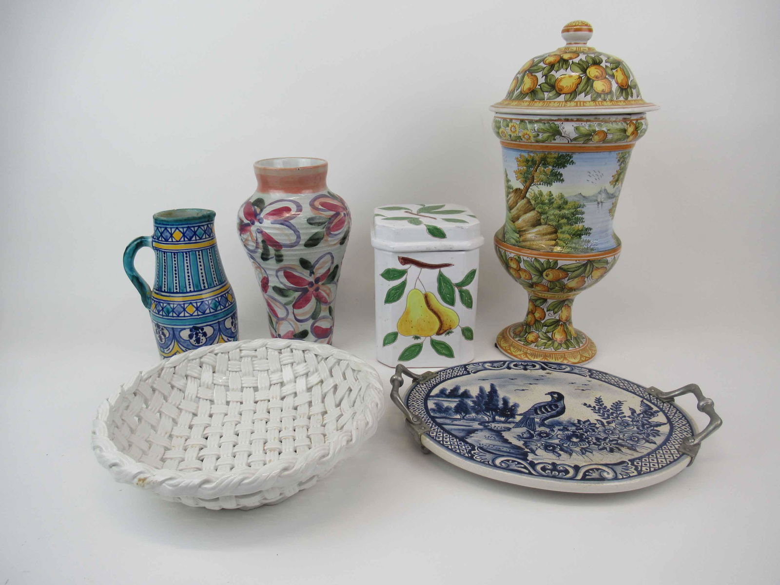 Group of Assorted Ceramic Table Articles: Group of Assorted Ceramic Table Articles. Including hand painted Italian covered urn, Italian painted canister, handled tray made in portugal, basket weave bowl, hand painted pitcher and vase. Used co