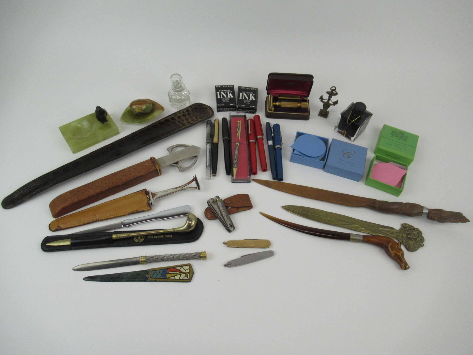 Group of Assorted Desk Articles: Group of Assorted Desk Articles. Including Horse form letter opener, Penguin onyx and onyx ashtray, P Roche letter opener, crane desk set opener, pocket knives, German tape measure and assorted founta