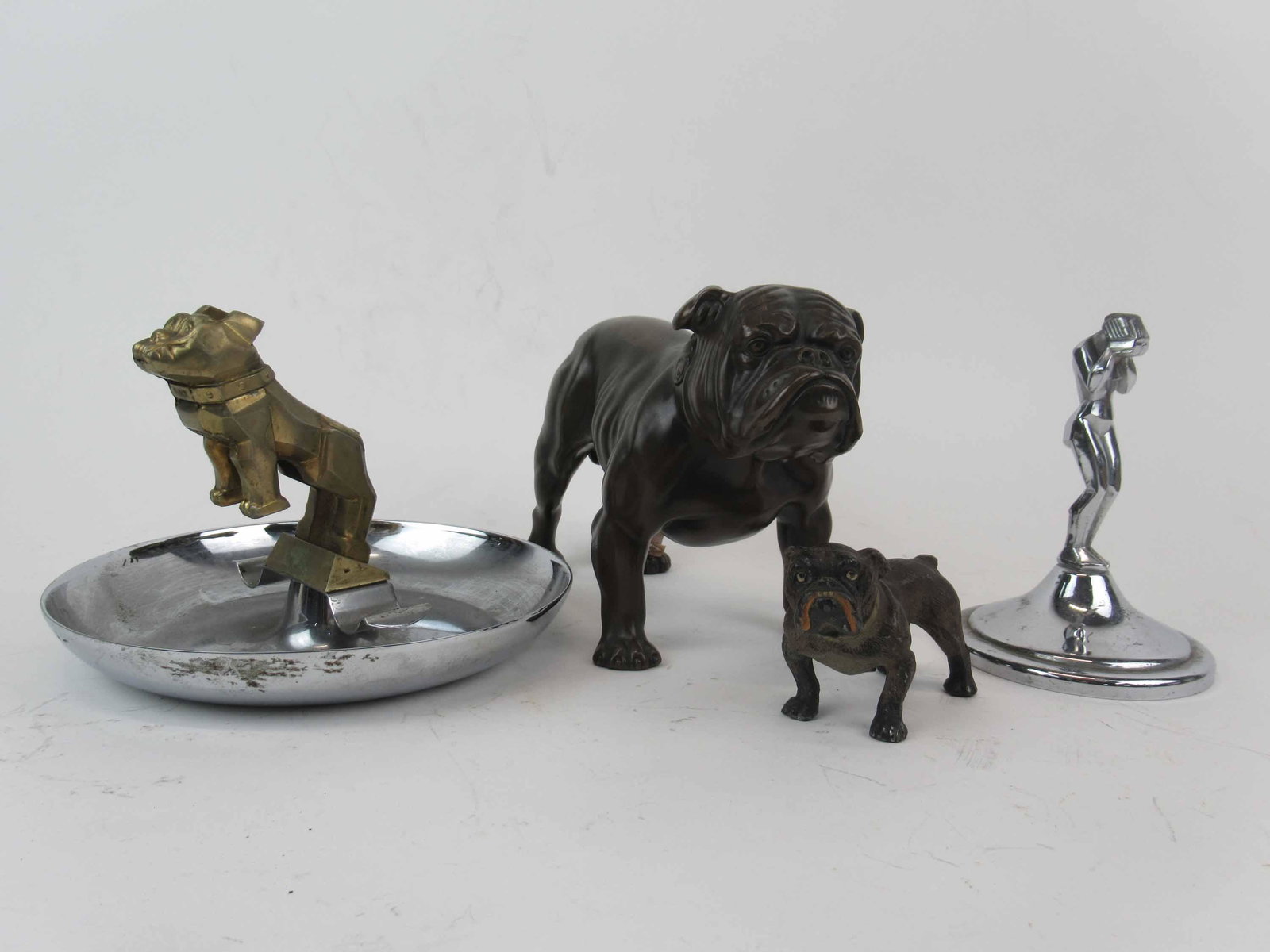 Mack Trucks Bulldog Cigar Ashtray: Mack Trucks Bulldog Cigar Ashtray with chrome base, loose. Together with a Art Deco nude ornament, Jenning Bros bronzed spelter bulldog broken tail, cold painted metal bulldog marked Germany. Used con
