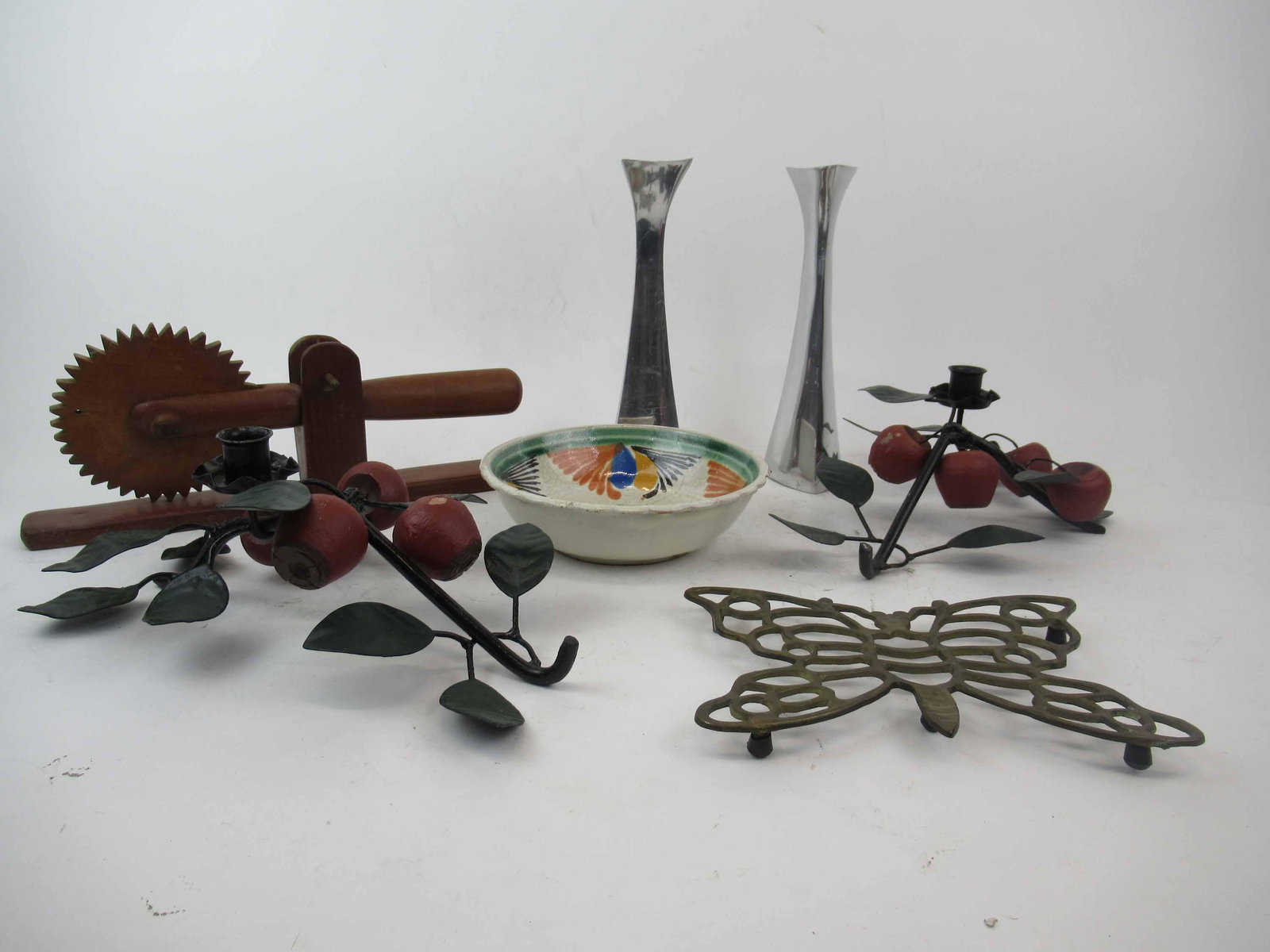 Pair of Modern Nambe Candlesticks 596: Pair of Modern Nambe Candlesticks 596. Together with a Vintage Wooden Pie Bread Crimper, pair of apple decorated candlesticks, pottery bowl and brass butterfly trivet. Used condition, chips, paint fla