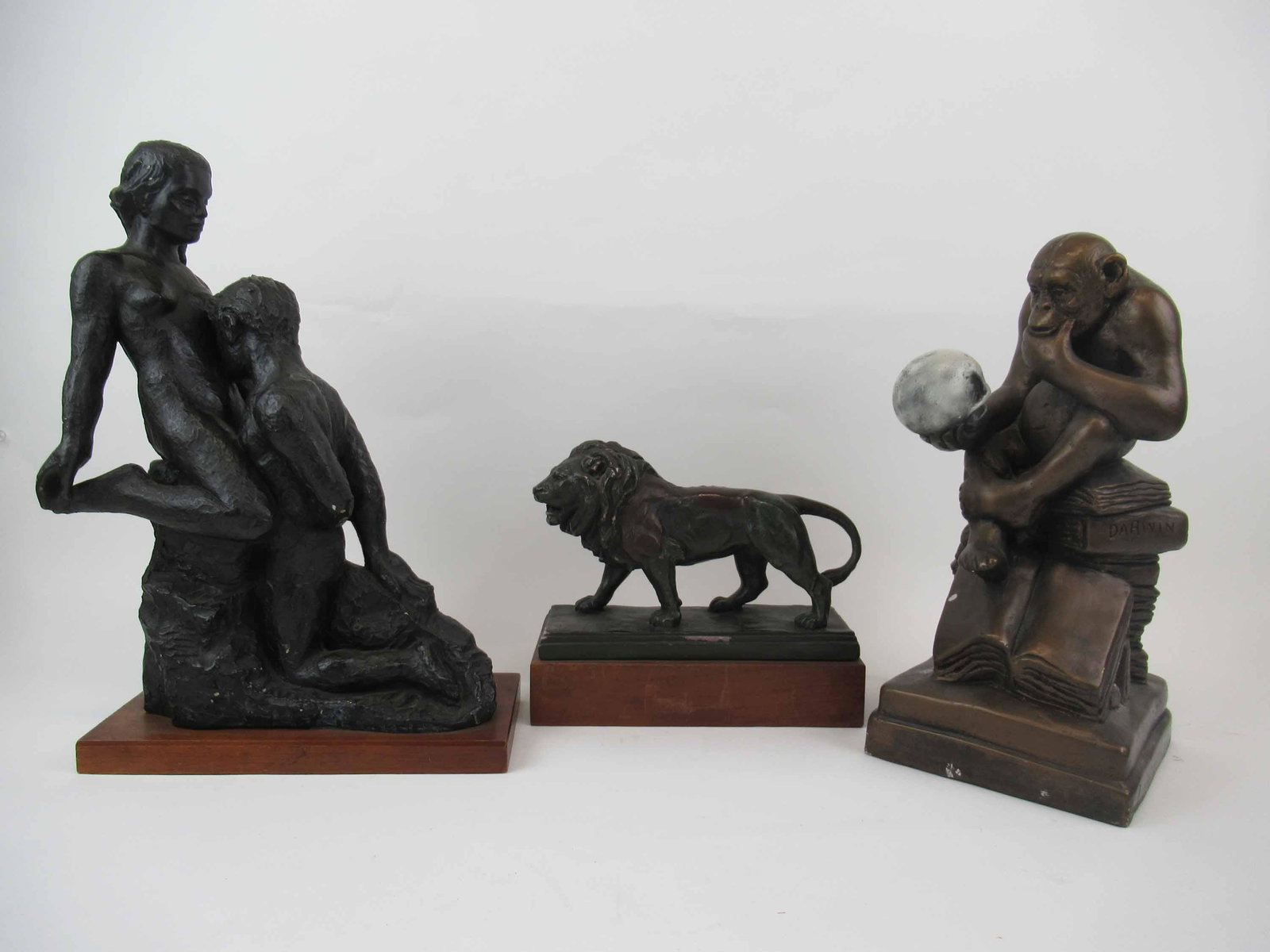 Austin Productions Darwin Composition Sculpture: Austin Productions Darwin Composition Sculpture. Together with an Austin Production 1962 statue of nude couple and Alva Studios composition sculpture of Lion. Used condition, wear, worn, nicks, chips.