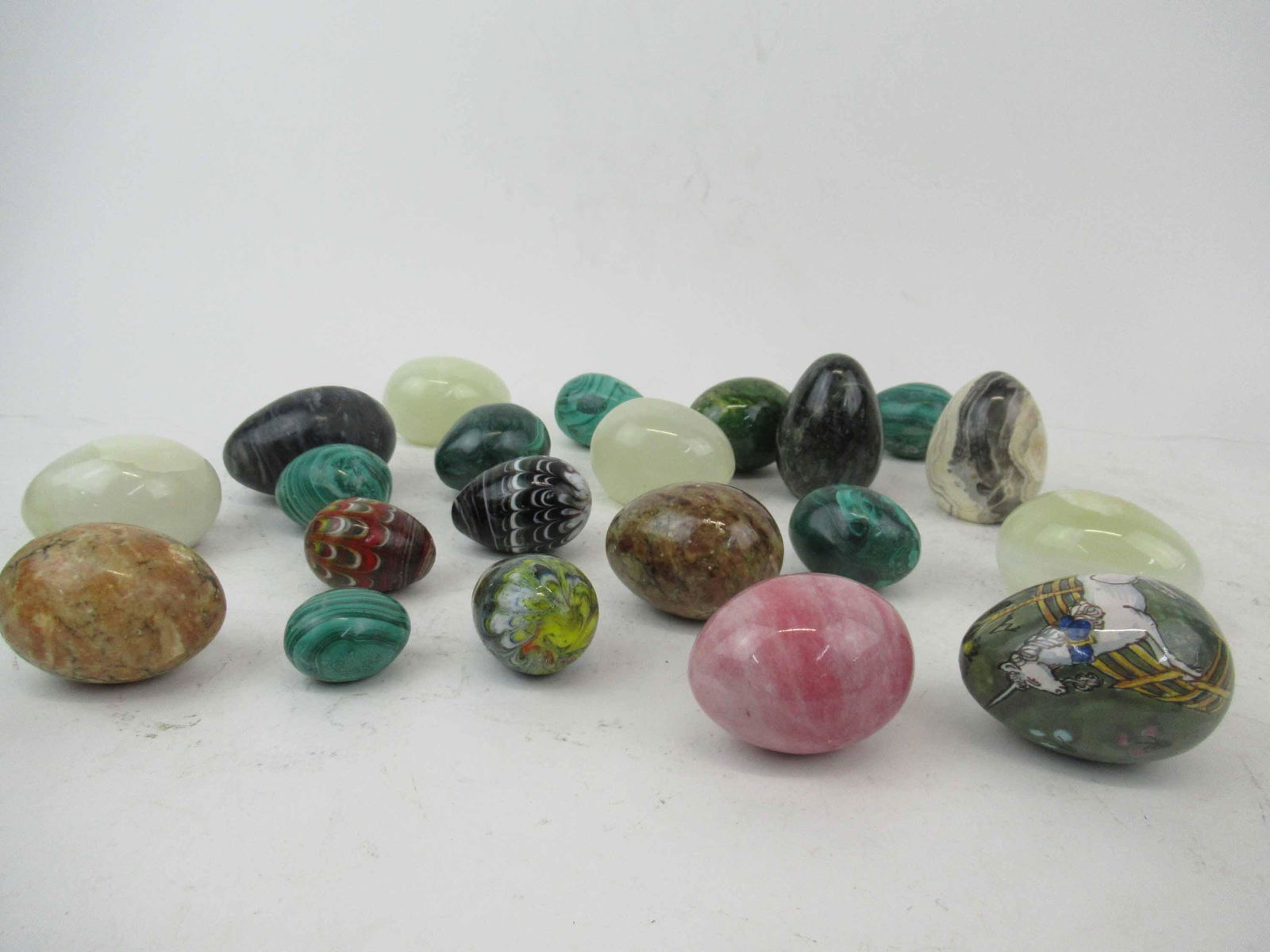Group of Assorted 21 Hardstone Eggs: Group of Assorted 21 Hardstone Eggs. Including quartz, glass and malachite eggs. Used condition, some scratches, some have flat bottoms.