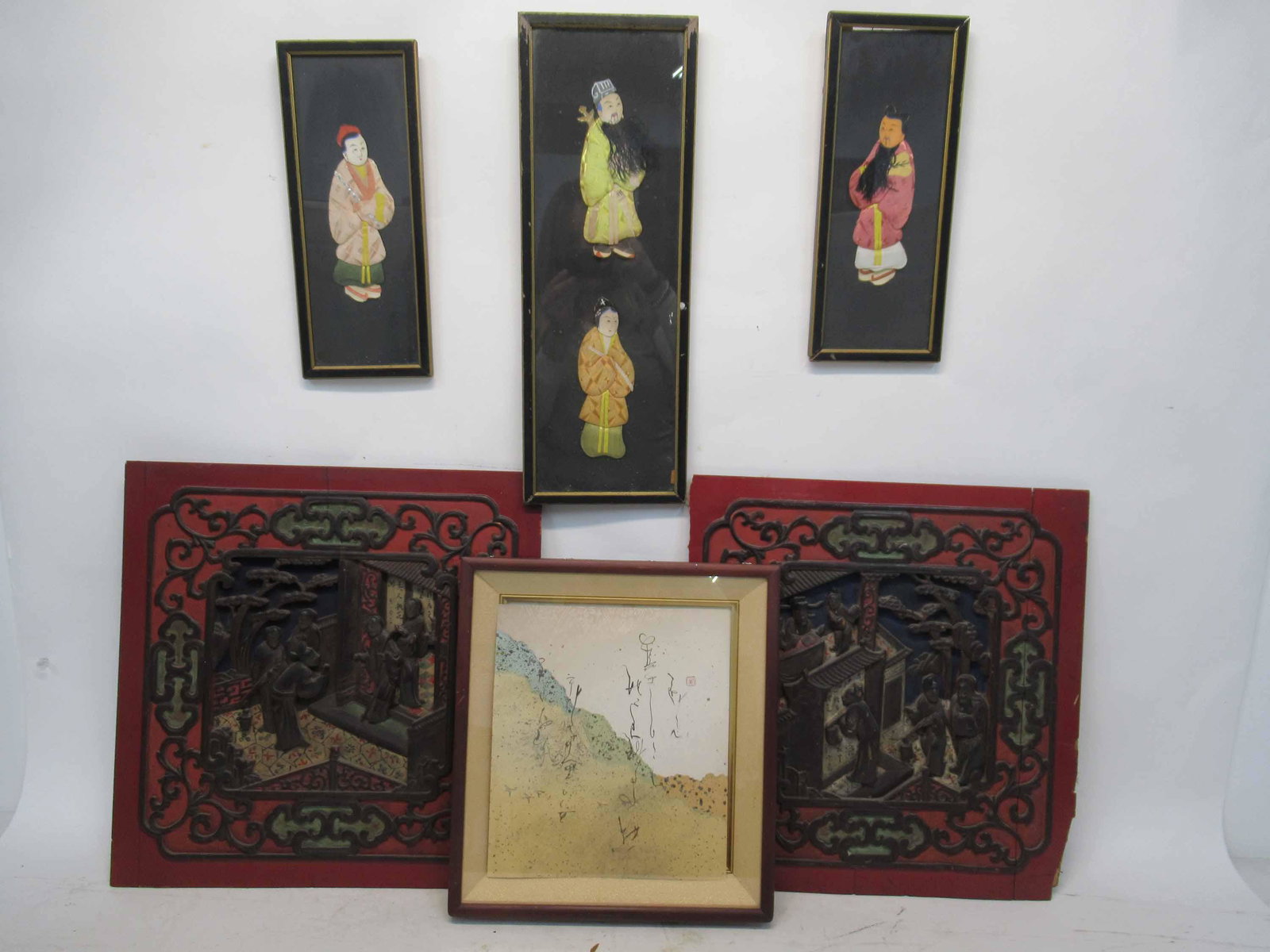 Two Red Lacquered Asian Panels: Two Red Lacquered Asian Panels possibly depicting temple scenes. Together with inscribed artwork on paper and three fabric cutout artworks of figures. Used condition, damage, wear,worn. approx panel s