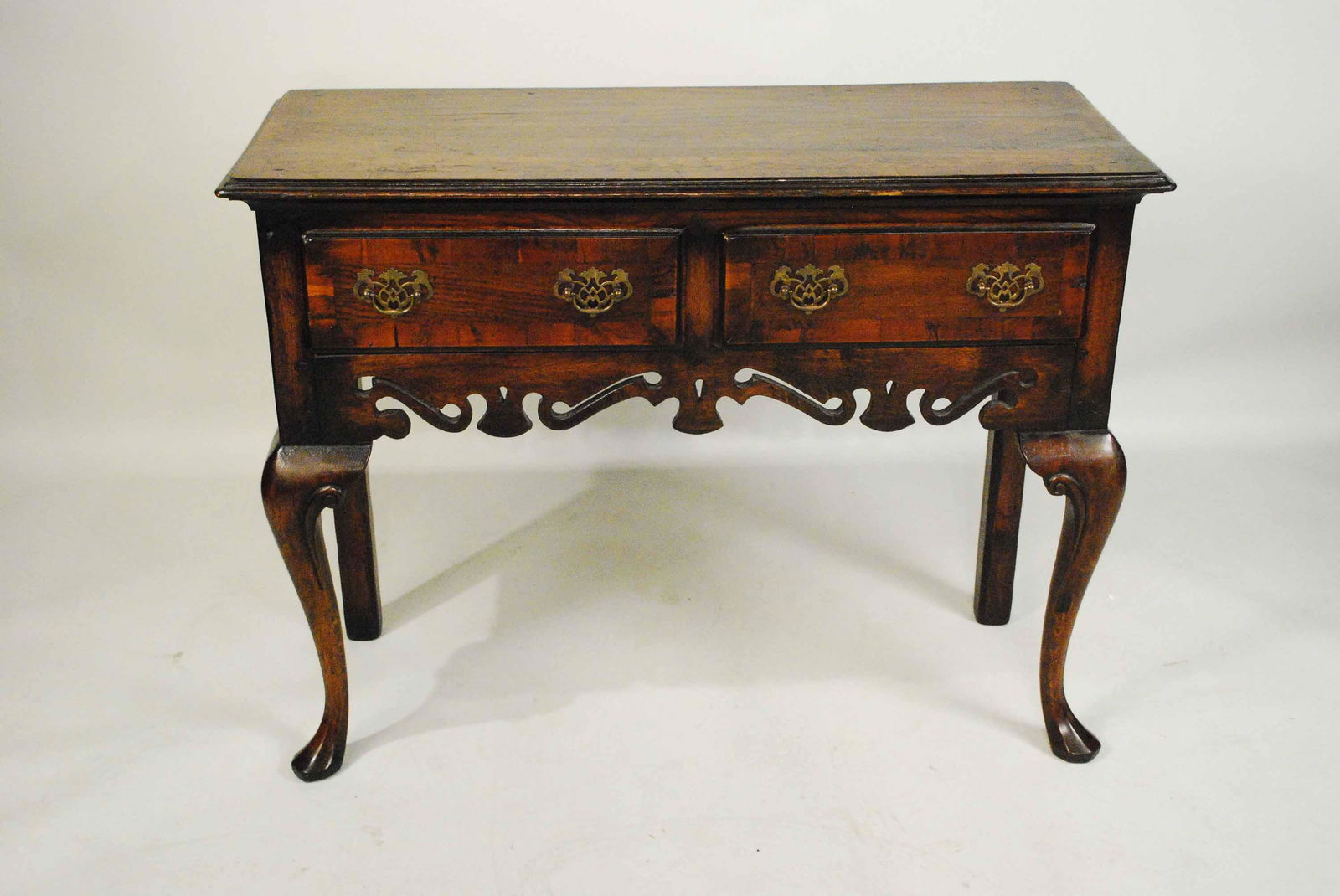 Welsh Style Oak Two Drawer Side Table: Welsh Style Oak Two Drawer Side Table having a banded and boarded top above two drawers with a scrollwork apron. Used condition. 32" tall x 42 1/2" long x 17" deep
