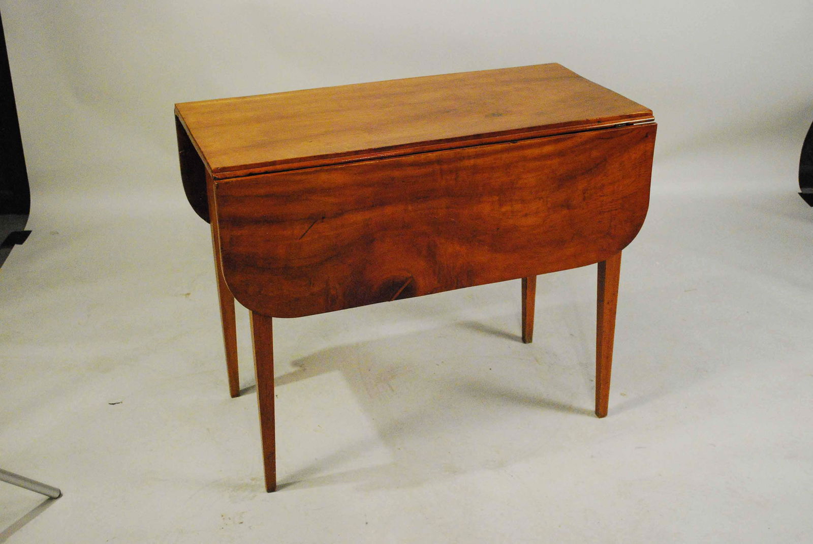 Antique Federal Hardwood Drop Leaf Table: Antique Federal Hard Wood Drop Leaf Table having single drawer. Used condition, wear, scratches. size with leaves down 29" tall x 36" long x 18 1/2" wide.