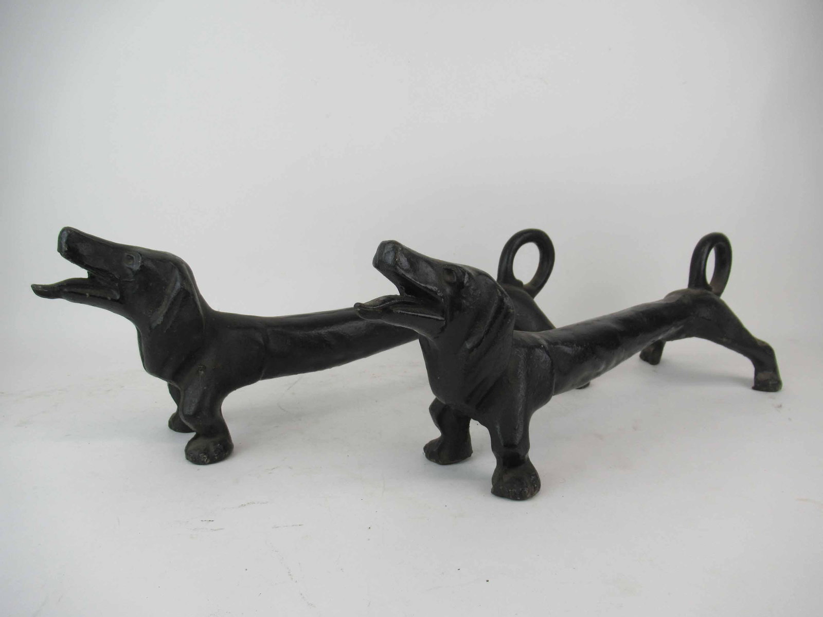 Pair of Cast Iron Dachshund Fire Dogs Andirons: Pair of Cast Iron Dachshund Fire Dogs Andirons, painted black, wear/worn, paint loss; measures 23" long x 7 1/4" wide x 7" high