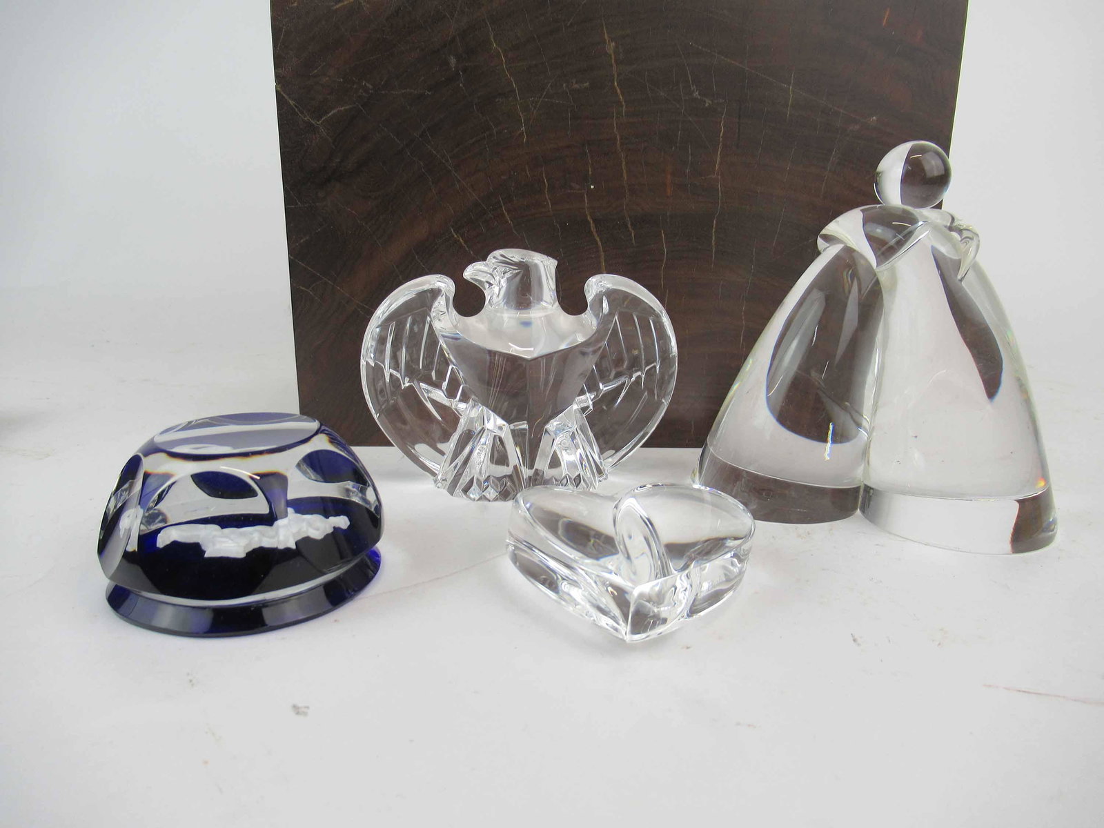 Group of Assorted Steuben Crystal Paperweights: Group of Assorted Steuben Crystal Paperweights. Including an Eagle, embracing couple and a wedding heart gift. Together with a Baccarat Sagittarius Zodiac paperweight. Used condition, minor scratching