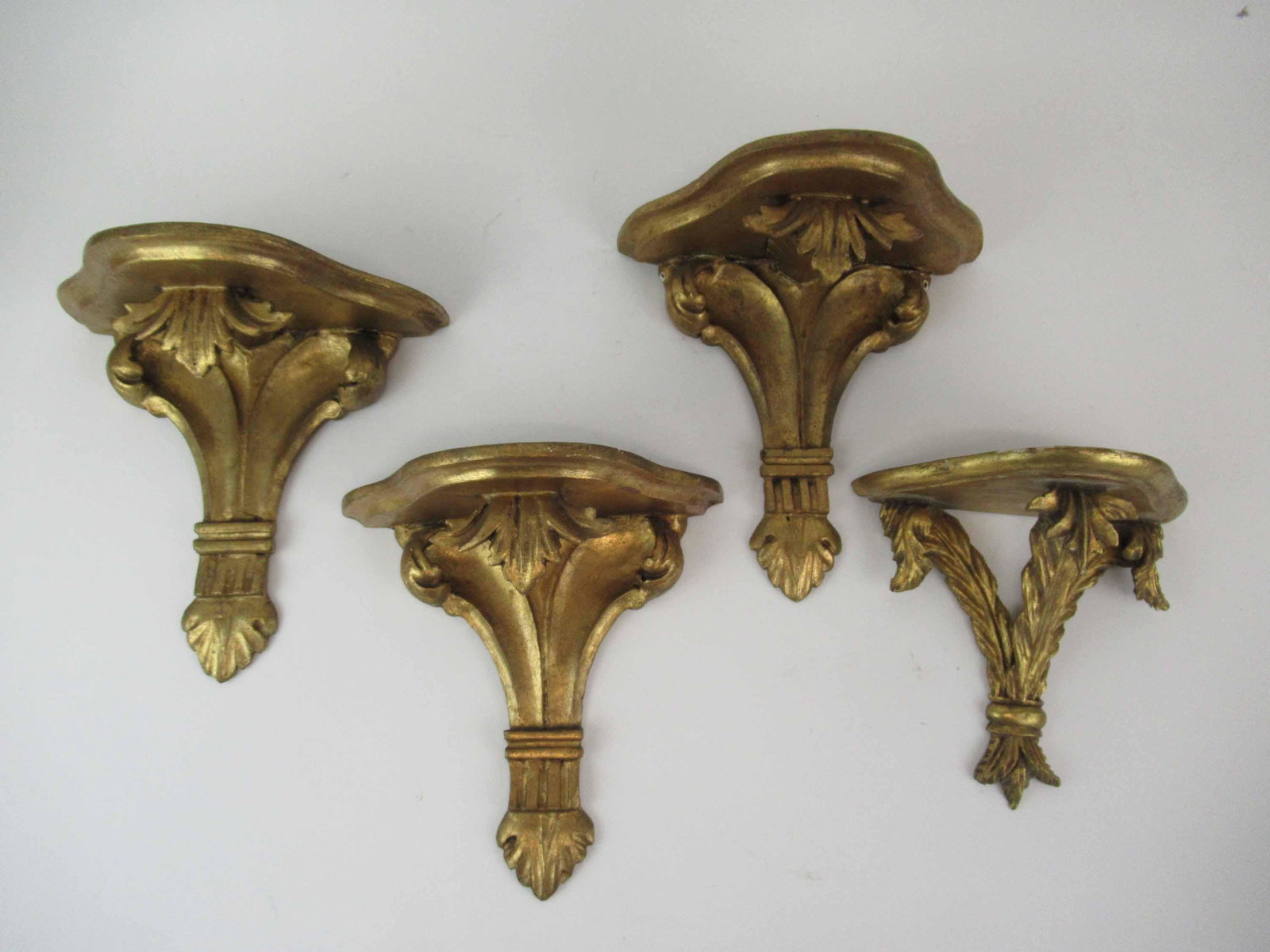 4 Carved Italian Giltwood Wall Brackets: 4 Carved Italian Giltwood Wall Brackets, three of identical size. Used condition, wear/worn, chips and paint loss, largest measures 9 1/2" long x 9" wide x 4 3/4" deep