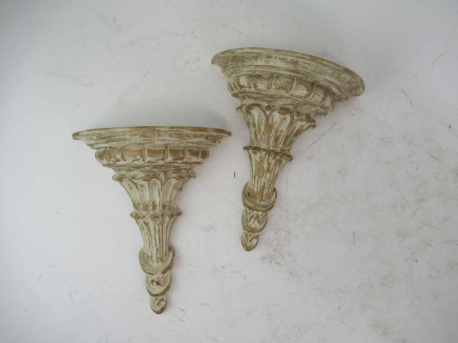 Pair of Contemporary Composite Wall Brackets: Pair of Contemporary Composite Cream and Gilt Wall Brackets; used condition, wear/worn, minor chipping, measuring 10" long x 8 1/4" wide x 4" deep