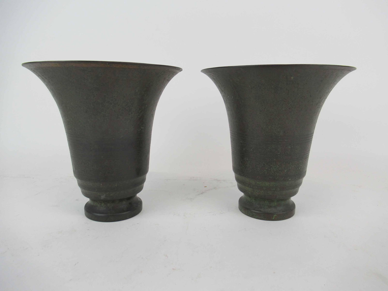 Pair of Carl Sorensen Bronze Vases: Pair of Carl Sorensen Bronze Vases. Used condition, wear, in bottom of one has part of stuck plastic up and pennies. No extra charge for pennies. 6 1/2" tall x 6 1/2" diameter