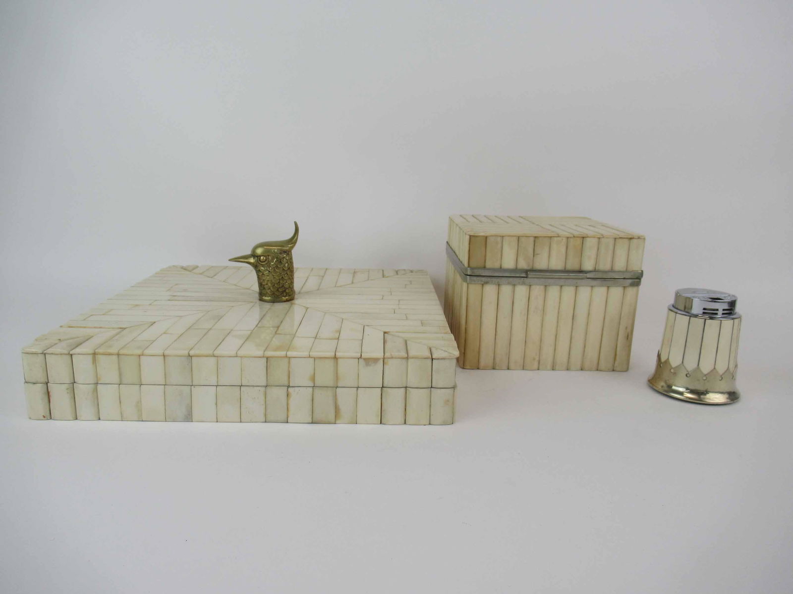Anthony Redmile Bone and Silver Metal Lighter: Anthony Redmile Studio Bone and Silver Metal Lighter together with two bone inlay decorative boxes, one with silvered hinge, the other with brass bird handle, largest measures 12" L x 12" W x 2" H, us