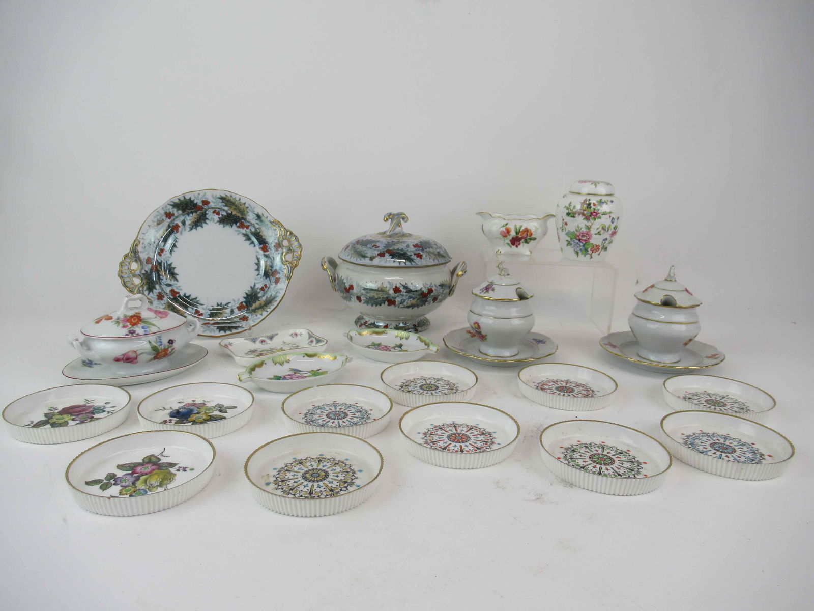 Group of Assorted Porcelain Table Articles: Group of Assorted Porcelain Table Articles including a small antique Davenport tureen with underplate in the Holly pattern, eleven Royal Worcester coasters, three German lidded condiment/mustard pots