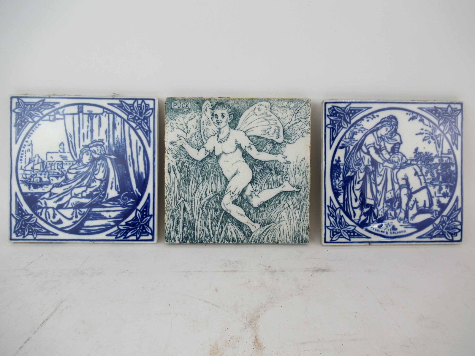 Three Antique Shakespeare Transfer Printed Tiles: Three Antique Shakespeare Transfer Printed Tiles. Including 6" Wedgwood Puck tile from a Mid Summer Nights's Dream by Hellen Ja Miles, Minton and Hollands of Rosalind & Orlando tile, The other is Lore