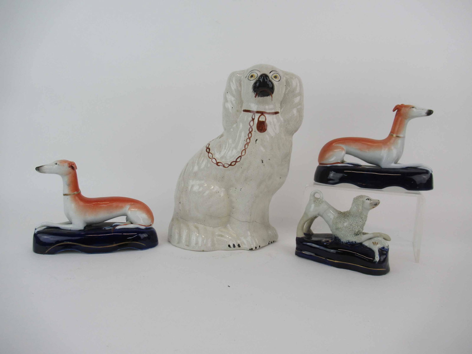 Group of Staffordshire Dogs: Group of Staffordshire Dogs. Including Large Spaniel and two Whippet pen holder. Together with a Confetti pen holder. Used condition, large spaniel has hairline cracks, whippet has broken ear, repair 