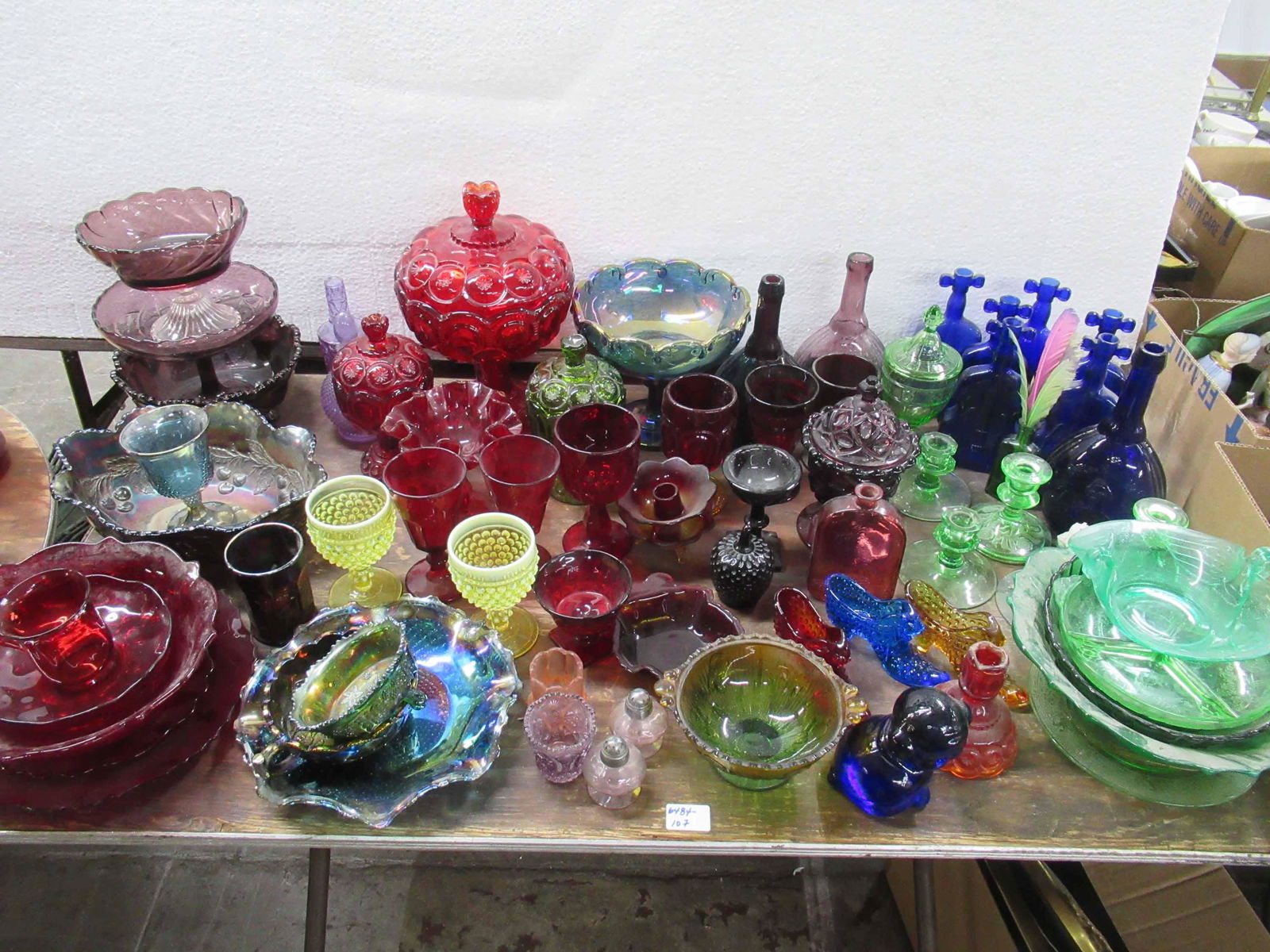 Large Group of Pressed Glass: Large Group of Pressed Glass including carnival glass and some depression glass, covered compotes, water goblets, candlestick holders, footed compotes, toothpick holders, Victorian shoes, bottles. Use
