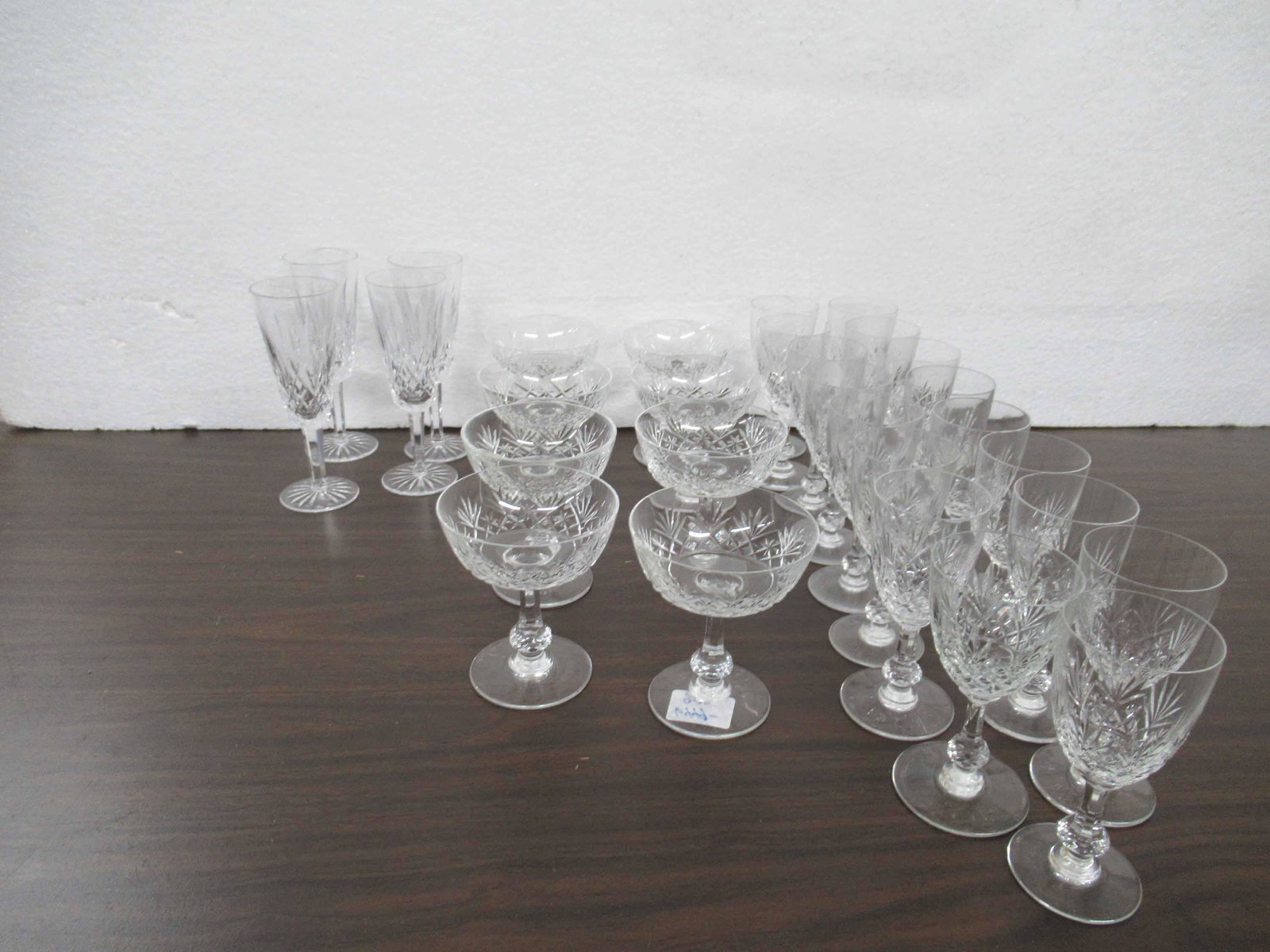 Group of St Louis Crystal Massenet Stemware: Group of St Louis Crystal Massenet Stemware including 16 burgundy wine glasses (5 3/4" high) and 8 champagne glasses together with four Waterford crystal champagne flutes in the Lismore pattern, used 